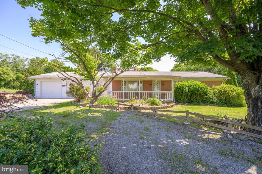 MUST SEE! Enjoy country living sitting on the large front porch of this brick raised rancher overlooking beautiful farmland near historic Shepherdstown and Shepherd University. Home features two (2) bedrooms, kitchen, living room, dining room w/exit to a large tiered deck, full bathroom, breezeway w/laundry, plus a large partially finished basement w/woodstore, storage and 2 car attached garage. Amenities include hardwood floors, central air, chain link/wooden fence for your animals, outbuilding, Koi Pond and close proximity to medical facilities, C & O canal, public boat launches, all commuter routes, and schools. All located on 1.91 acres.   Make your appointment today to view this home. Great location!!