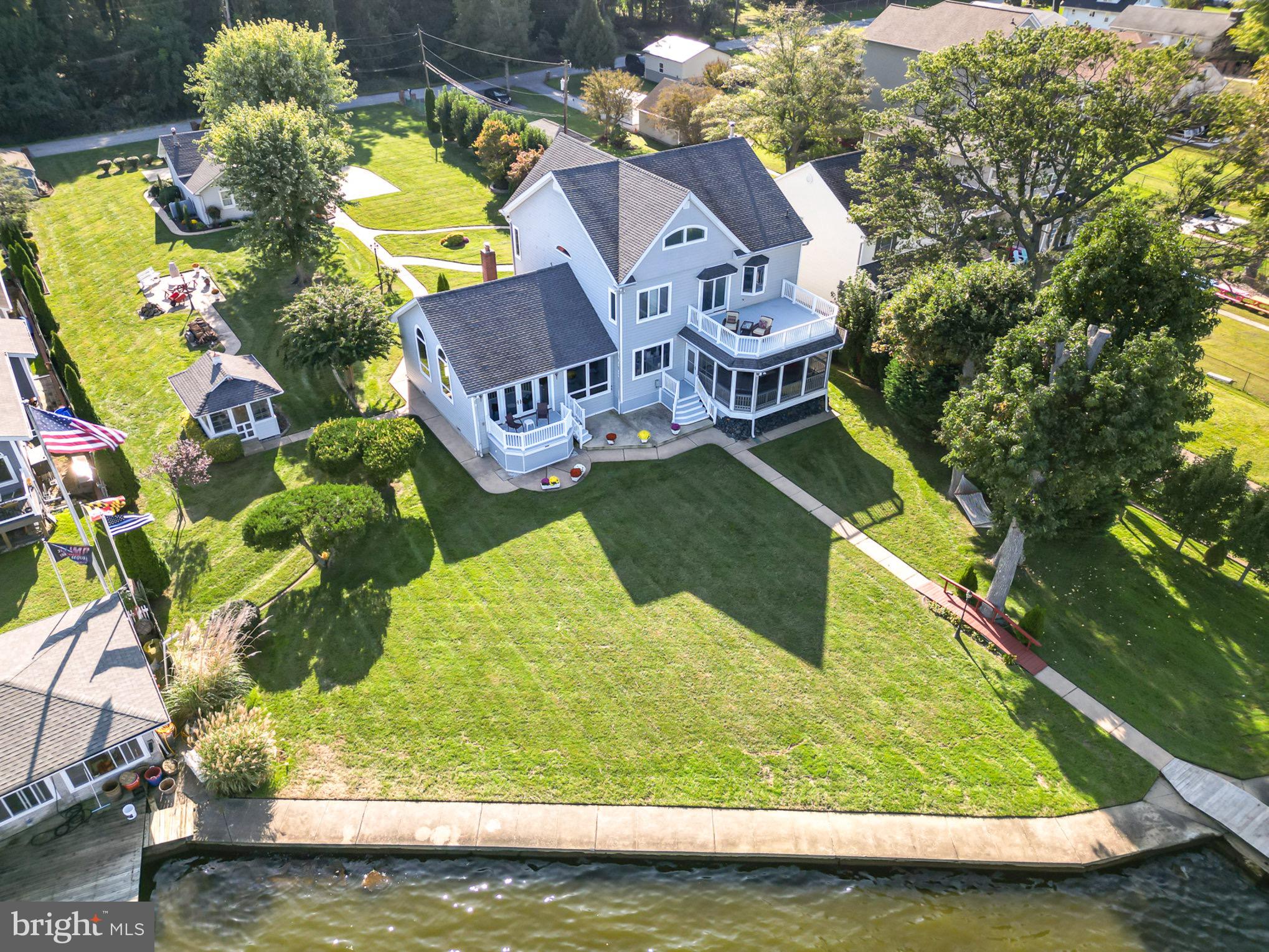 Welcome to this absolutely phenomenal 3 story waterfront home in Sparrows point on a large beautiful lot. This is a custom built, well maintained, 3 story, 4,266 sf waterfront home with expansive views of Rocky Point and Hart Miller Island, situated near the mouth of Back River. This home has two sheds, a crab shack/gazebo, 2 car garage with workshop and second level, a boathouse, and pier with a few boat slips. The house itself has a main level bedroom suite with full bath, a 3 season room, and decks on the first and second level. There is a total of 5 bedrooms and 3.5 baths. This house is gorgeous and has everything you dreamed of! The extensive pier/dock area includes a 20,000 pound boatlift, a grandfathered-in covered boathouse with two lifted slips and adequate dockage for additional watercraft. Water depth average 4'. The house itself is set back from the street on a large manicured lot. Pull into the large driveway and park on the 4 car parking pad and take a short walkway among the landscaping up to the large covered front porch. Walking in this beautiful home brings you to a tiled foyer that has a wide tiled hallway that leads through the main floor straight to the rear door. To the right is the gourmet kitchen with a massive granite island, custom maple cabinetry, with under cabinet lighting, high end stainless appliances, multiple sinks and more. Adjacent to the kitchen is a butler pantry with cherry wood cabinetry, another sink, compact dishwasher and refrigerator. Passing through the butler pantry leads to a massive great room. This room is where you want to spend your time, flush with windows giving you a clear picturesque view of the water behind the home. This massive room has 13' vaulted ceilings, a gas fireplace with two tiered mantle and French doors that lead out onto a rear deck and patio. This room circles into a formal dining room with a tray ceiling, chair rails and crown molding and a large picture window overlooking the gorgeous water views. There are French doors on both side of dining room in case privacy or quiet is desired. The other side of the dining room leads back into the main hallway. Back in this hallway is a large walk in laundry/mudroom, a first floor powder room, as well as a main floor owners suite. This bedroom has its own private entry/exit to the rear sunroom, a walk in closet and private bath with jacuzzi tub and walk in shower. French doors from this bedroom and the main hallway both lead out into the rear three season room with its own wet bar that gives you views and access to the rear yard and water beyond. Off of this room is another uncovered deck and patio below. This patio has walkways that connect it with the dock, all other patios and structures and every entrance and exit to the home. Back inside, taking the stairs to the second floor brings you to a full bath with tub/shower combo, and three bedrooms, including a second primary suite with a large walk in closet, and private bath with a soaking tub overlooking the water, and a stand up shower. This room has French doors that also open out onto a private second story deck with amazing views. Taking the next set of steps to the third floor brings you to another living area with a 5th bedroom, also with its own private bath. There are extra rooms for storage up on this level as well.
This house has it all, every thing was thought of and done with extreme care. The home has so many custom upgrades and was done with remarkable quality. Please ask your agent for the list of upgrades and benefits to this home that is enclosed in the documents of this listing. You will be blown away! Come see your new waterfront oasis today!