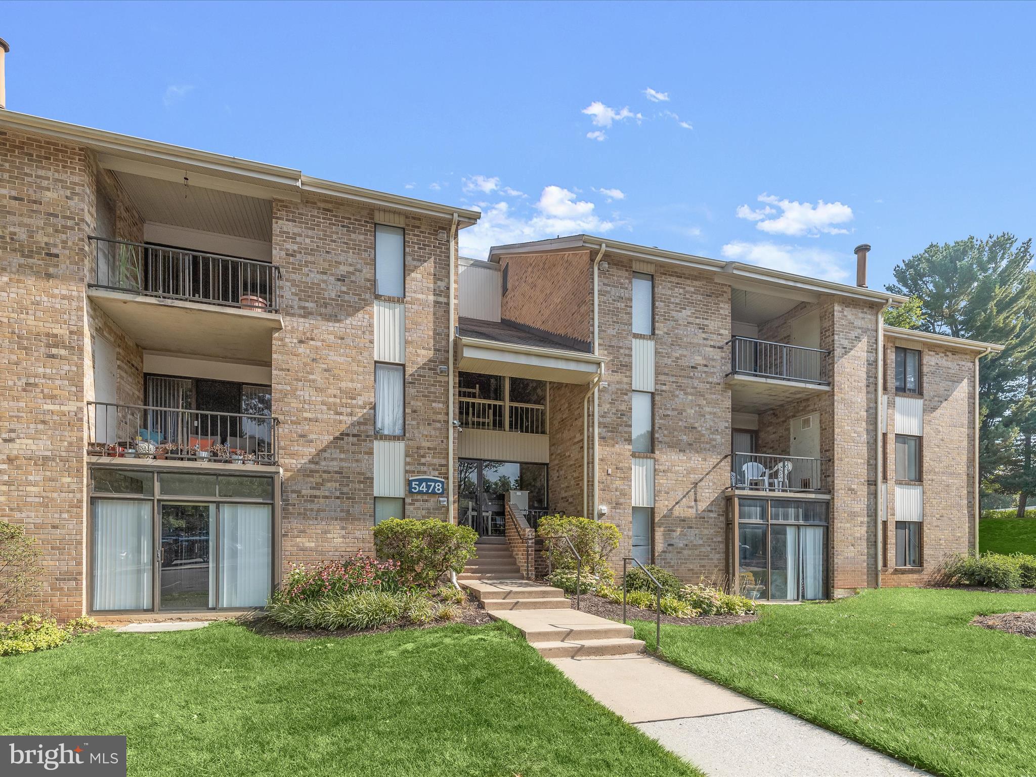 Welcome to this stunning top-floor condo, where modern updates, low-maintenance living, and a prime commuter-friendly location in the heart of Columbia await you. As you step inside, you'll be greeted by laminate plank flooring and a neutral color palette that enhance the spacious, open floor plan. The living and dining areas are bathed in natural light from large, lofty windows that offer serene views of mature trees. The expansive living and dining room combination is perfect for entertaining or relaxing and features a sliding glass door that opens to the deck, seamlessly blending indoor and outdoor living. The kitchen is a chef's delight, with granite countertops, stainless steel appliances, a stylish tile backsplash, and cabinets accented with updated hardware and undermount lighting. It also boasts its own sliding glass door to the deck, making alfresco dining a breeze. At the end of the hall, the primary bedroom offers a peaceful retreat with a walk-in closet and access to a dual-entry bath. This cleverly designed bath includes two separate half baths connected by a shared shower room, updated with chic vanities, lighting, and a modern shower surround. Additional conveniences include an in-unit washer and dryer and a hallway walk-in closet for extra storage. The community offers ample unassigned parking and the building features a secure entrance. Located close to schools, downtown Columbia, The Mall in Columbia, shopping, dining, entertainment, and Columbia association amenities, this condo also provides easy access to major commuter routes like US-29, I-95, and MD-32. Experience the perfect blend of comfort, style, and convenience in this beautiful condo. Please note: some photos have utilized virtual staging.