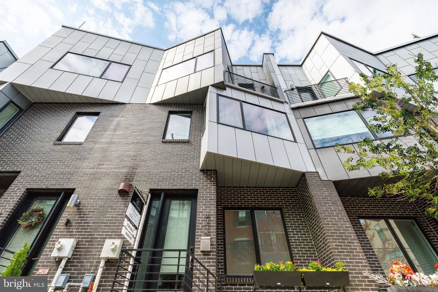 An architectural gem located in the heart of Northern Liberties, 822 N Lawrence Street is part of the exclusive SEVENTEEN townhome collection, a gated enclave showcasing modern luxury and elevated design. This stunning residence offers approximately 3,300 square feet of thoughtfully designed living space across four meticulously crafted levels, blending industrial-inspired elegance with contemporary comfort.

From the moment you enter through your private 2-CAR GARAGE, the attention to detail and upscale finishes are evident. The striking graphite brick and aluminum composite façade set a bold tone, while inside, you'll find three spacious bedrooms, three and a half spa-like bathrooms, and a fully finished basement that functions beautifully as a media room, fitness space, or optional fourth bedroom. The home features soaring 9’ to 14’ ceilings, wide-plank hardwood floors, Pella Architect Series windows, custom steel stair railings, and a built-in Sonos sound system with ceiling speakers in the kitchen, family room, basement, and primary suite.

The Poggenpohl kitchen is outfitted with a Thermador Professional appliance suite, sleek soft-close cabinetry, and quartz countertops, making it ideal for both everyday living and entertaining. Numerous upgrades elevate the home further, including a whole-house water filtration system with triple 20" carbon filters and a five-stage reverse osmosis drinking water system at the kitchen sink. A striking Ortal three-sided glass gas fireplace with a custom chimney anchors the living space, complete with media-ready wiring and an articulating mount for a 55" television.

Smart home features include Nest door locks, thermostats, and CO/fire detectors, along with LED recessed lighting throughout. Each bedroom and the family room feature custom built-in closets, with additional storage cabinetry in the guest bedroom. The home is fully ethernet wired across all living spaces—including the basement, garage, and kitchen—ensuring seamless connectivity. The basement includes a media and utility closet wired for multiple devices, a 40-foot HDMI run, articulating tv wall mount for kitchen, basement and primary bathroom, and substantial additional storage, including custom cabinetry and an extra refrigerator. The garage is fully outfitted with two ceiling-mounted 4’x8’ storage racks, bike racks, a pegboard system with hooks, a full slatwall with baskets, and a large workbench with built-in cabinetry.

Luxurious bathrooms are finished in marble and Porcelanosa tile and feature Grohe and Toto fixtures. Dual high-efficiency Lennox HVAC systems provide year-round comfort, and the home is further enhanced by a Honeywell smart thermostat system and Aiphone video intercom security. A private green roof deck with pilot house access offers sweeping city views and an ideal space for outdoor entertaining or relaxation.

Located in one of Philadelphia’s most dynamic neighborhoods, this home is just steps away from beloved local favorites like Cafe La Maude, Honey’s Sit ’n Eat, Green Eggs Café, and Liberty Lands Park, with nightlife and entertainment nearby at The Piazza, Urban Village Brewing, and North Bowl. With TAX ABATEMENT remaining, 822 N Lawrence Street offers a rare opportunity to own a truly turnkey luxury home in one of the city's most sought-after communities.