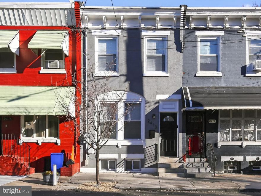 This well-maintained Philadelphia row home offers a classic layout with thoughtful updates, consistent finishes, and flexible living space across all levels. Set on a residential block, the home balances traditional character with modern functionality, making it well suited for both owner-occupants and long-term investors.

The main level features rich hardwood floors, high ceilings, recessed lighting, and extensive custom wainscoting throughout the living and dining areas. Large front windows provide excellent natural light, while crown molding and detailed trim add architectural interest. Ceiling fans and recessed lighting enhance comfort and usability. The layout flows naturally from front to back without wasted space.

Toward the rear, the kitchen is practical and well-appointed, featuring solid wood cabinetry, granite countertops, stainless steel appliances, tile flooring, and a breakfast bar with pendant lighting. The kitchen opens directly to the dining area and provides access to the private rear yard, making it functional for everyday living and entertaining.

Upstairs, the home offers well-proportioned bedrooms with hardwood flooring, neutral finishes, and good closet space. The full hall bathroom features tiled tub surrounds, updated fixtures, and a clean, timeless design. The upper hallway continues the home’s consistent trim and finish details.

The finished lower level provides valuable additional living space, suitable for a media room, home office, gym, or guest area. This level also includes a second full bathroom, a dedicated laundry area, and additional storage, adding meaningful flexibility beyond the main living floors.

Out back, the property features a private, fenced rear yard with a concrete patio—ideal for outdoor seating, grilling, or low-maintenance use. The rear elevation includes a second-story addition, increasing interior space while maintaining privacy.

Conveniently located near public transportation, Temple University, and major roadways, 2413 N Carlisle Street presents a move-in-ready opportunity with solid condition, functional updates, and long-term upside in a steadily improving area of Philadelphia.