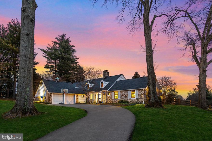Great opportunity and true value on SHEAFF Lane. Rarely does an offering like this become available on coveted Sheaff Lane, nestled on a gorgeous piece of land spanning 4 scenic acres, neighboring the bucolic Highlands Preserve. 7012 is an expanded 4-bedroom stone cape styled residence that effortlessly blends a chic modern farmhouse design centered around a curated chef’s working kitchen. You are immediately greeted with a sense of place and tranquility.
The back sanctuary, first seen as you enter the home, is framed with specimen trees that include varieties of magnolias, katsura, hemlock, beech, redwood, cypress, red buckeye, and holly trees like any fine arboretum.  Within that frame is a fully restored “Hamptons-styled” saltwater heated pool, waterfall, jacuzzi, full service with full bathroom pool house and garden that includes sage, azalea, daisy, boxwood and English lavender.  Market lights on timer extenuate the setting at dusk. Your home has been carefully renovated (New Windows, New Roof, etc.) for today’s hectic lifestyle with high end finishes, appliances and captivating attention to detail.  Adding to your Zen, is 60+ acres of recently protected open space out your front door for walking, horseback riding or birding.  Surrounding the newly renovated kitchen, anchored by the 48” Elise Edition Aga gas stove, is an original brick floor sitting area with day bed and a gas fireplace.   One side of the kitchen opens up to the library with lighted bookshelves and a log-lighting large wood burning fireplace.  The view from the Library to your backyard is breathtaking in ALL seasons!  Adjacent to the kitchen is a brand-new walk-in California Closet pantry with a desk area and a mudroom with built-in cubbies adjacent to the attached 2-car garage.  On the opposite side of the kitchen sits the George Nakashima inspired living space; excellent for entertaining that includes two spacious sitting areas and a dining room. Next to the Library is a primary suite wing that includes an ample supply of closets, bathroom, foyer and stone floor study. Upstairs connected via two staircases are two independent living spaces.  One side includes two bedrooms and a full bath that can be configured as a suite.  The other side includes a dramatic two-story bedroom with wood beams, full bath and sitting area.  Both 2nd floor suites have separate entrances for ultimate privacy.
The basement has been  finished and includes a full modern bathroom.  Heading down the stairs is a secondary storage area for the kitchen that currently houses an additional refrigerator, a freezer and wine cooler that are tucked away behind three sliding solid white doors.
Entering the finished area, you’ll find an open space that can be configured for a personal escape such as entertainment, TV binging, and work out space. The ceiling has been soundproofed and added storage space is tucked away with a walk out exit. The basement has a sump pump, French drain and has been waterproofed.  Outlets, electrical switches, and lighting have all been updated.  New electrical wiring with a new subpanel has been installed.  A new upgraded gas line has been installed as well to meet the needs of any future expansion if so desired.  A detached springhouse greets you on the lower entrance of the horse-shoe drive if you wanted to add a party room or home office. 
A beautiful setting, prime location and elegant living quarters define this stunning 5000 sq foot gem. Located a short distance to the bustling town of Ambler and nearby to several private schools and major arteries. A terrific opportunity in an A+ location! A true value!