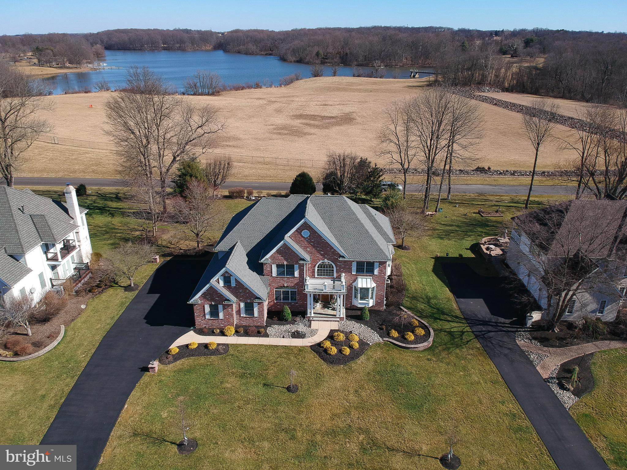 This Peaceful and Stunning Location is on a quiet street backing up to Lake Luxemburg in Core Creek Park. The water views are spectacular on this unique offered location.  The home is well maintained, with over 4500 sq/ft and an indoor Lap pool. The first floor is spacious featuring a large eat-in kitchen flowing into the large family room with a beautiful fireplace filled with lots of light and warmth and there are 2 office areas (one of the could be used as a 5th bedroom if desired). The heated indoor swimming pool is located adjacent to the kitchen .  There is a nice living room and a formal dining room combo ideal for entertaining those family dinners.  The roof was replaced recently and the home comes with 3 zone heating and cooling , all of the units have been replaced in the past 4 years. The Primary bedroom is massive complete with a dressing area, a full bath, a walk-in closet a large storage area that could easily be another closet, it also has a balcony for overlooking the tranquil back yard and a stairway to the floored attic which is enormous. To complete the second floor there are 2 more full bathrooms and 3 spaciously sized bedrooms with a laundry shoot. If you like to entertain then you will love the brand new Therma Spa Hot tub that sits on a gigantic deck overlooking the park. The basement is equipped with a Scandinavian Sauna, an exercise area and Lots of storage space and a walkout basement. Don't miss this opportunity to see this interesting home that is just minutes from Newtown Borough with many fine restaurants and shops just a few miles from 295 and major highways.