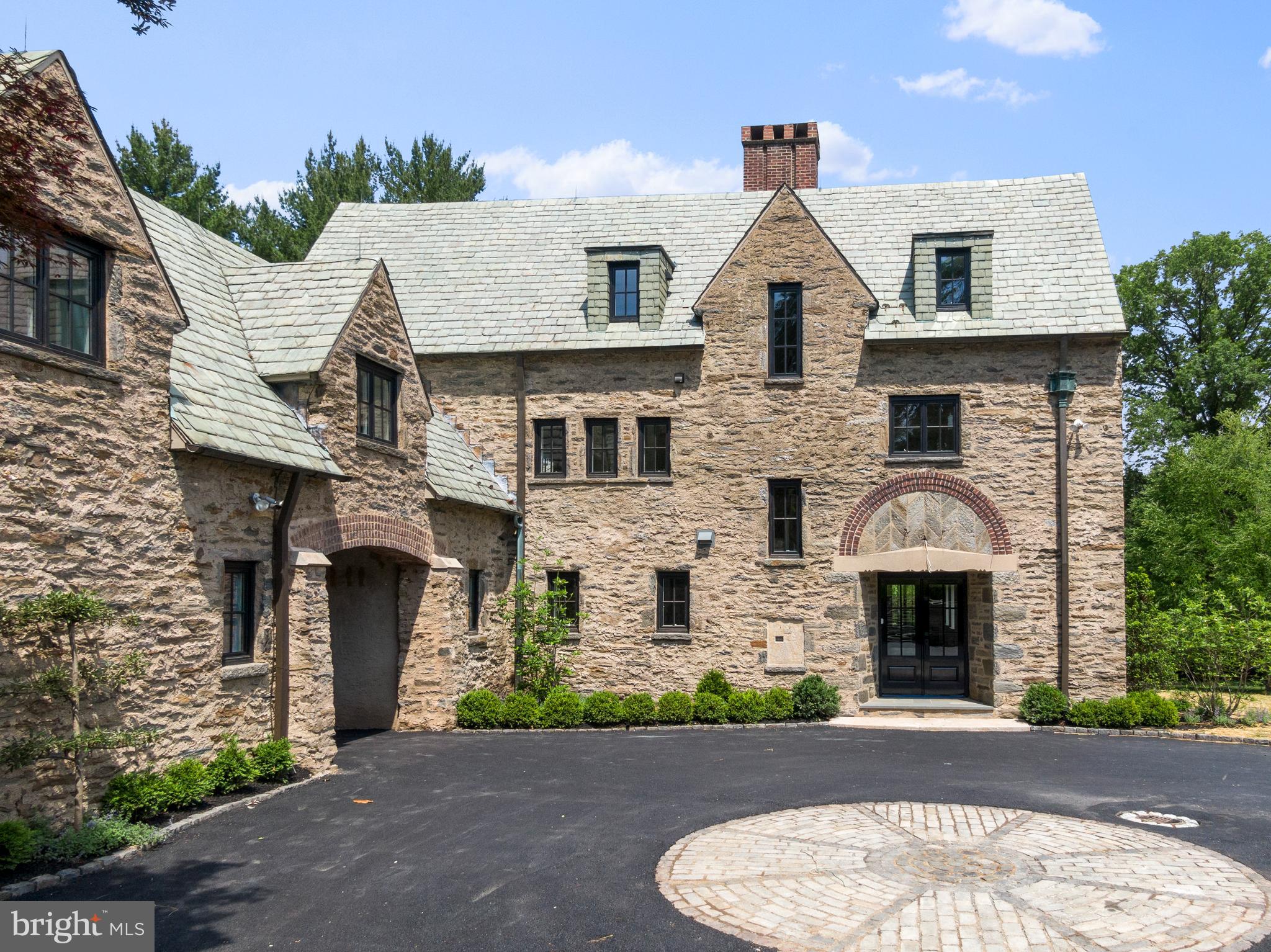 In a neighborhood that offers some of Philadelphia's most extraordinary architectural gems, this home is one of the finest. Welcome to 8750 Montgomery Avenue, an exquisite English Country residence that has undergone a comprehensive renovation by award winning and renowned custom builder, Blake Development. You will love every inch of this fabulous home, masterfully sited on 1.68 acres. The traditional floor plan, "opened up", offers 6000 plus square feet, ideal for today's preferred lifestyle. Features include step down formal living room with fireplace and bar, dining room family room and screened porch each with a fireplace, all opening onto excellent outdoor spaces, offering a large flagstone terrace. Gourmet kitchen features custom cabinetry, marble countertops and large island, Sub Zero refrigerator/freezer, beverage refrigerator, Wolf range/ovens, hood and microwave and Bosch dishwasher. Adjoining pantry is designed in the classic English style. Mudroom thoughtfully appointed with custom cubbies and cabinets. Upstairs, five bedrooms, four full baths and a bonus/gameroom. Fabulous master suite with spacious walk in closet and bath with soaking tub, shower, marble tile, Kohler sinks, toilets and Waterworks fixtures. Lovely sitting room or office with French doors opening onto spectacular balcony views. The finest millwork and hardwood floors throughout include new Andersen windows, Wissahickon schist exterior, slate roof with copper gutters and flashing. Heated 2 car garage with new carriage door. The lower level offers ample storage and a 600 bottle wine room. High efficiency Buderus/Bryant HVAC, Advent security system, stereo sound wired 1st floor, and Primary Suite. Extensive mature landscape plan, reimagined and designed by Mary Costello. This is a rare combination of a classic Philadelphia home with all the modern amenities you could wish for, in a coveted Wyndmoor location within walking distance to Chestnut Hill and Wyndmoor shops, restaurants, schools and public transportation. Take advantage of a quick commute to Center City and just 90 minutes to Manhattan.