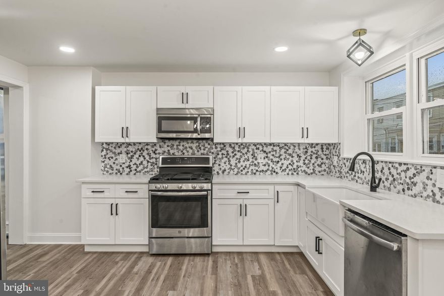 Welcome to 535 Glendale Rd, a reimagined 4-bedroom, 2.5-bath rowhome where classic charm meets bold, modern design. Step through the statement black door and into a bright open layout with warm wood accents and sleek finishes throughout. The designer kitchen features shaker cabinets, quartz countertops, a farmhouse sink, and a striking mosaic backsplash. Upstairs offers 3 spacious bedrooms and a spa-like bath, while the finished basement adds a guest suite, home office, or gym with a full bath. Enjoy the comfort of central air, luxury flooring, and recessed lighting throughout. Conveniently located just 2 blocks from Stonehurst Elementary School, within walking distance to multiple public transportation stops, and only a short drive to Center City Philadelphia, the airport, or shopping in King of Prussia.  This move-in-ready home blends modern comfort with unbeatable accessibility.