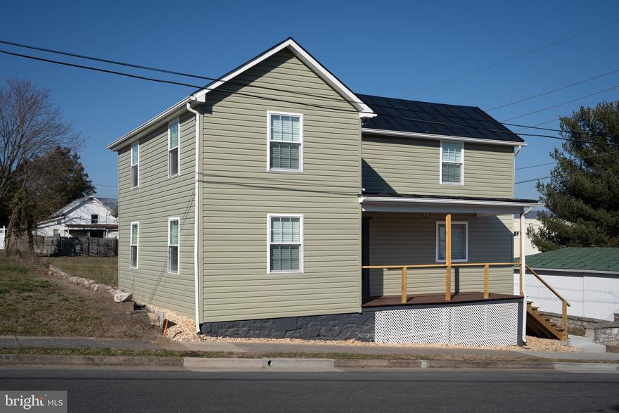 Historic Charm Meets Modern Comfort in Downtown Luray!
Discover this beautifully reimagined 1928 farmhouse in the heart of downtown Luray—steps from shops, restaurants, the brewery, Hawksbill Greenway, and the local library. Fully renovated in 2023, this historic gem combines timeless charm with modern design across every detail: updated electrical, plumbing, flooring, appliances, and more. Inside, the kitchen is a showstopper with soft-close cabinetry in forest green and crisp white, accented by crystal knobs and a classic farmhouse sink. Two tall pantry cabinets frame the refrigerator and offer ample storage for food and appliances. Natural light fills the open dining area and living space, where large windows connect you to the walkable neighborhood beyond.
Upstairs, two spacious bedrooms each feature en-suite bathrooms with tiled walk-in showers, sleek backlit mirrors, and a sophisticated, modern aesthetic. A convenient half bath is located on the main level for guests. The home sits on an elevated lot with backyard mountain views, a rare find in town. Accessory buildings, including an old carriage house, offer room for imagination—whether for extra storage, workspace, or future expansion. Zoned R3, this property is eligible for a special use permit to operate as a short-term rental (permit must be applied for separately), giving you the flexibility to use this home as a full-time residence, second home, or income-producing asset. Best of all? It’s being sold fully furnished with a beautiful, curated design package—making it truly turn-key.