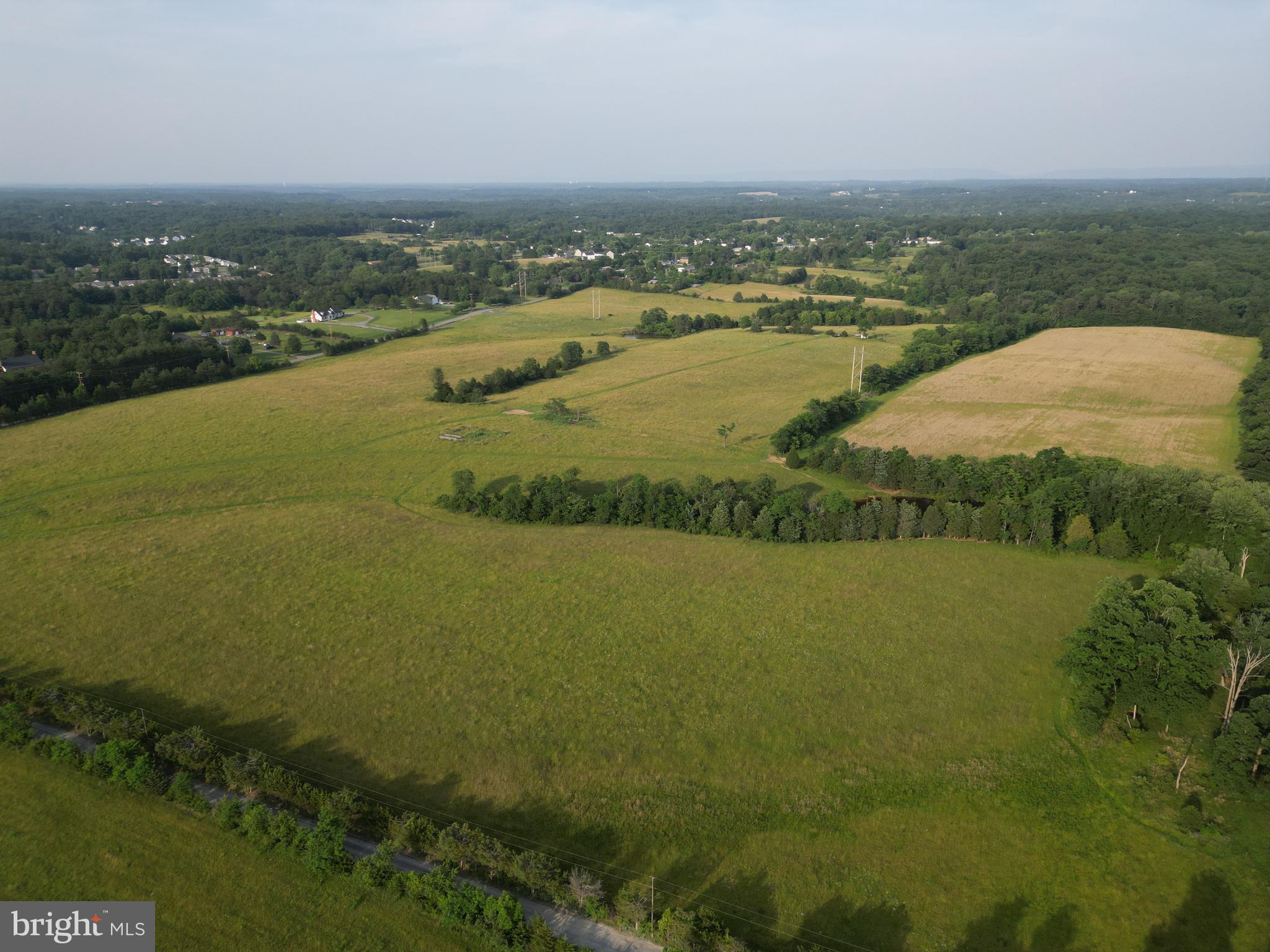 Take a look at this beautiful farm that has not been offered to the public since 1959. Made up of large fields that were previously used for cattle and hay production are now awaiting new owners. This is a prime location for a developer looking for an investment or future project. The property is perfectly located between 81 and Charles Town on a main connecting travel corridor. Much of the ground sits on gently sloping hills with small wetlands and ponds in the valleys making fantastic focal points for development or wetland credits. Give me a call to schedule a showing today.