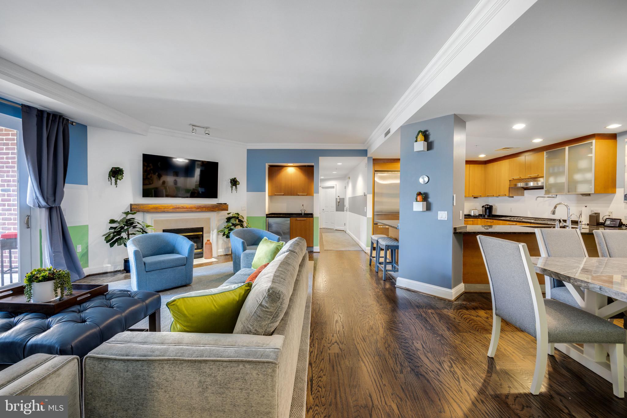 Welcome to the epitome of luxury living at the Ritz-Carlton Residences in Baltimore, where stunning sophistication meets urban tranquility. Enjoy the style of this boutique remodel and allow this 3 bedroom & 3.5 bathroom condo to add the splash of color in your life you are looking for! This unit showcases an open concept floor plan that elegantly blends living, dining, and entertaining spaces & boasts exclusivity as the elevator opens directly to the unit. Upon entry, you are greeted by a stunning and bright foyer, leading to the open living room boasting breathtaking views from the balcony. The space features beautiful ceiling details and a cozy fireplace, creating an atmosphere of unparalleled sophistication. The spacious kitchen is a chef's dream, offering ample cabinet and prep space, featuring professional grade stainless steel appliances, beautiful wood cabinets, granite countertops, and a grand island with extra storage and seating. Additional features include a pot filler faucet on the cooktop and sleek range hood, as well as a separate bar area in the living room with a mini fridge and sink. A half bath located in the main entertaining area adds convenience for guests. The primary bedroom is a luxurious retreat with large windows showcasing stunning city views, accent walls, and an en suite bathroom that defines opulence. The en-suite bathroom features all marble, a dual vanity with abundant storage, a massive soaking jacuzzi tub, and a large stall shower. The second bedroom provides ample space for guests and includes an attached bathroom for added comfort. A third room serves perfectly as a home office or additional living space, also with a full bathroom attached. Your oversized private balcony is an outside oasis that adds a spectacular extension to your living space. Relax and entertain friends and family, with a serene setting to enjoy the views and fresh air. Lease includes utilities and wifi! 2 parking spaces - 1 private and 1 valet. The Ritz-Carlton offers a wealth of 5-star amenities for residents, including 24/7 concierge, valet, porter service, 24/7 security, beautifully landscaped grounds, numerous community spaces for relaxation, a meeting area, game room, spacious gym, indoor heated salt water pool, board room, club room, party room, access to the Art of Balance spa, 6 guest suites, and stunning views of Baltimore Harbor from the private promenade. Located in the heart of the harbor, with easy access to Federal Hill and directly across from the park, this condo offers not just a home, but a lifestyle of luxury and convenience. Don't miss out on this rare opportunity. Schedule your showing today to experience the epitome of urban living. At the Ritz-Carlton, everyday living is effortlessly transformed into an exceptional lifestyle experience.