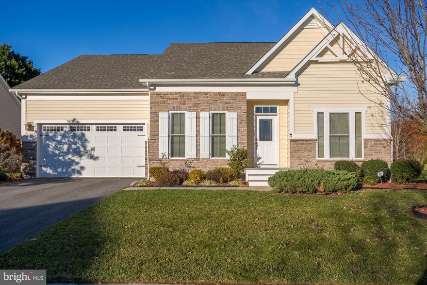 Redden Ridge community is within a mile of Beebe/Abesinnio health complex as well as route one with all of its restaurants, stores and attractions, 15 minutes to Lewes beach and 20 minutes to Rehoboth Beach boardwalk and beach.

As you stand at the front door of 31733 Carmine Dr., take a minute to look around at the quality neighborhood of Redden Ridge. Glance up and down the street then get ready to see a quality interior.  But first, take note of the exterior with its stone front (Aspen selection) and exterior color scheme (Delray Sand).
Walking in the door, the first thing you will notice is the striking dining room on the left with its tray ceiling, crown moulding,  paneled walls, and chandelier (brushed nickel) - and especially the natural light flooding in.
On your right is a full bathroom (tiled floor and shower/tub) serving the two adjacent guestrooms.  Continue on (notice hallway with ARCHES) into the chef's kitchen with the GE stainless steel appliances, upgraded, paneled cabinets and glassed in kitchen hutch.; the lengthy granite (luna pearl) counter with double sink, eat-in seating, recessed and pendant lighting.  ALSO  -  the two-door refrigerator, built in microwave, wall oven, and NATURAL GAS cooktop.
The kitchen opens up in one direction into a true morning room facing east for that morning sun,  and in another direction for the living room,  Both rooms combine for amazing natural light. The living room also adds a cathedral ceiling, gas fireplace with slate surround, flatscreen tv (conveys) over the fireplace and ample socializing space.  NOTICE: a combination of hardwood, tiled and carpeted floors.
In another direction leading from the kitchen, is a hallway housing the laundry (Samsung washer & dryer), and going into the 2-car garage to the left and Owners' Suite to the right.
The Master Bedroom includes a large walk-in closet, tray ceiling with moulding, chandelier and more natural light, and leads to a large Master Bath with two vanities, of Cararra engineered stone each with its own sink, brushed nickel fixtures; tiled floor, soaking tub, stand-alone glassed-in shower.  Toilet is placed for privacy.
Basement is large and finished with carpet, recessed lighting, private outside access, full bath with tub/shower and tiled floor, three unfinished rooms which could be built into bedrooms or left as-is for storage
BE SURE TO LOOK EVERYWHERE AND FIND QUALITY.