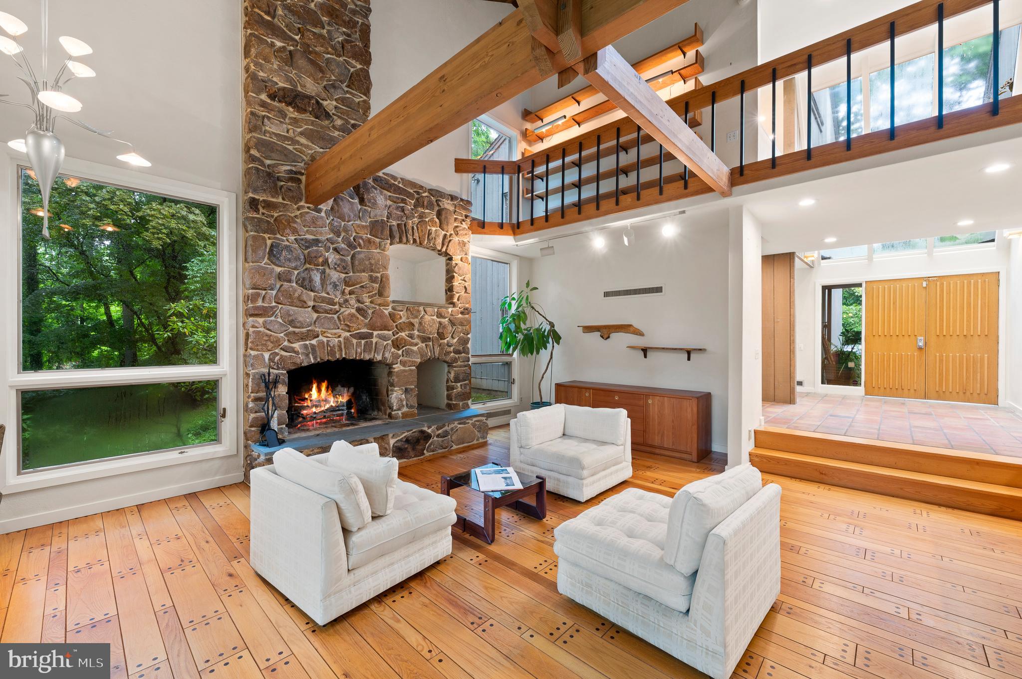 Recent price improvement. Seller says sell! Welcome to Stillpond! A rare oasis of 2.27 acres of wooded property in the highly coveted, walkable, neighborhood of St Davids-Walk to Wayne! This 4 bedroom, 2.5 baths custom built, contemporary home is one of a kind and overlooks a pond, waterfalls, a stream and your very own GROTTO with stalactites and a fairy tale like stone bridge. Situated off of an extremely private cul de sac, down a long drive to the home with extra parking along a stone sitting wall. Enter through double doors to a bright, sunlit, 2 story foyer with skylights. Step down to the gracious living room with floor to ceiling windows offering views of the amazing property, a buttress beamed ceiling and a stone fireplace (floor to ceiling) with 2 custom built in wood and art storage/display boxes. Random width, wide oak, peg hardwood floors. Adjacent is a dining room with a bar and built in marble countertops and cabinets/shelving. Adding more natural light is an L shaped, double walk out, set of sliding doors which offers amazing property views. Murano glass pendant lamps, hand selected from Italy, over the dining table add artistic flair to the Dining Room area.
Throughout most of the first floor the home has Mexican terra cotta tiles, neutral paint and décor, along with recessed lighting. Continue on to the family room/open kitchen area with welcoming white, KitchenAid appliances and a butcher block countertop. The Chantilly white walls are complemented by hand painted botanical tile backsplash (which matches the fireplace surround) and a custom wood ceiling. The large family area has a 2nd wood burning fireplace and a long wall hearth. The sliding doors lead to the large two tiered deck with wire railings overlooking the grotto and pond. Back to the entry foyer- on the right is a powder room and to the left is a coat closet both convenient for guests. Continuing down the hall to a very large home office/family room. This space could easily be converted to a first floor, primary bedroom suite. This room includes an atrium with spectacular views of the property, a custom oak wine bar, vinotemp cooled wine storage and custom oak bookshelves. There is an adjacent mudroom area with a side door and a doggy entry. The mudroom door leads to an estate fenced side yard and a walkway to an extra room above the detached 2 car garage which could serve as a workshop or playroom. SECOND FLOOR- Up the floating hardwood stairs to the second floor open balcony which overlooks the Living Room. To the left is the primary suite which is entered through a sitting/exercise/home office room adjacnet to the primary bedroom which has a fireplace and 2 walk in closets. The en-suite primary bath is a peaceful retreat with white Carrara floor tiles and countertops, double sinks and a walk in shower. To the right are 3 additional bedrooms and a shared hall bath. The mechanics of the home are located in a meticulously maintained Utility Room with an exterior entrance and include a Rain Bird irrigation, central vacuum, alarm system, a Weil Mclean boiler and more. All maintenance records are available along with dates of service. There is also a Kohler generator.
The property taxes are $19,904 and were included in the Delaware County reassessment 2021.
Conveniently located to take a leisurely walk to Saint Davids, the train, or downtown Wayne. A few blocks to 476 Blue Route highway, PHL airport and King of Prussia mall. Don't miss this one!