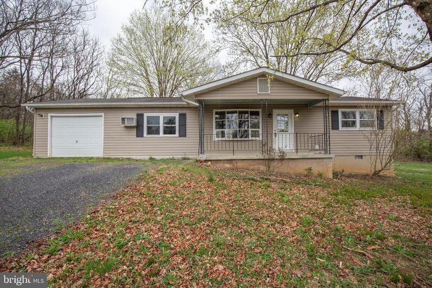 Cozy rancher on a tucked away wooded lot in the relaxing mountain setting of the Hidden River Neighborhood!

The bright, open living room with a bay window welcomes you and opens into the dining area and kitchen. The dining area has a center-hinged door that accesses the rear deck and generously sized unfenced rear yard. Off of the dining area is a large bedroom, which is conveniently next to the laundry room with full sized as-is washer and dryer and access to the rear deck and yard. 

Two additional bedrooms and a full bath are off of the living room. 

Parking is not a hassle with the large private gravel driveway and 1 car garage. 

1716 Hidden Hollow Drive is located off of WV-51 between Inwood and Charles Town; just 15 minutes from I-81 exit 5, and US-11. 

No Pets
Rent includes water and septic. Tenant(s) provide their own window units.

Additional monthly costs include Renter's insurance (price based on plan selection).