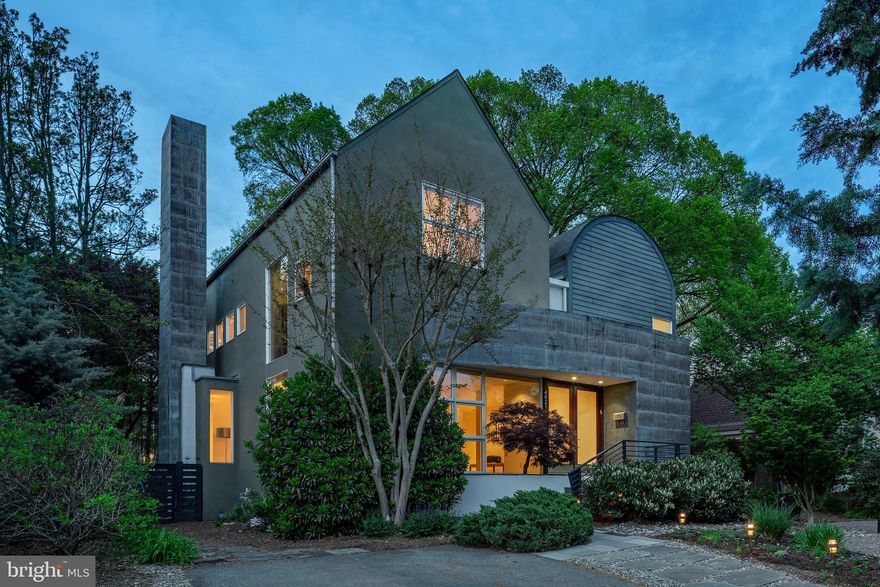Designed by award-winning architect David Jamison, this extraordinary contemporary residence—known as the “Push Pull” House—offers a rare blend of striking design, sophisticated function, and natural serenity just blocks from downtown Bethesda.

Thoughtfully renovated and meticulously maintained, the home features 4 bedrooms, 4 full and 1 half baths, including en-suite baths for all upper-level bedrooms. The dramatic two-story living area is bathed in natural light through soaring windows and enhanced by a recently installed electronic shade system. Surrounded by floor-to-ceiling windows, the main living area opens fully to a tranquil natural setting. The result is a dynamic central space that feels open yet grounded, perfect for everyday living and gathering with others.

At the heart of the home is a striking custom-designed kitchen. Outfitted with designer cabinetry, Caesarstone countertops, and premium appliances, the space balances modern elegance and practical function. Just off the kitchen, a window-wrapped sunroom provides a light-filled space currently enjoyed as an informal dining area, with easy flow to the outdoors.

The home also includes a formal dining room currently used as an additional living area, showcasing its flexibility in layout and function.

The primary suite offers a calming retreat with soaring ceilings, generous natural light, and a beautifully renovated spa bath. Highlights include a sculptural soaking tub, oversized glass shower, floating vanity, and high-gloss cabinetry. A spacious walk-in closet with additional washer and dryer hookups adds everyday convenience.

Outside, the home is framed by lush, low-maintenance gardens and a private patio oasis, ideal for quiet outdoor dining, relaxing with friends, or simply enjoying the peaceful surroundings. Thoughtfully planted herb and flower beds, deep bamboo screening, and a calm, low-upkeep garden setting offer privacy and beauty throughout the year.

Additional highlights include:

* A spacious lower level with a large recreation room or playroom, extensive storage, project space, and an informal guest suite

* Soaring ceilings and expansive window walls that immerse the home in natural light and all-season views

* A flexible front room that functions beautifully as a dedicated office, music room, or additional living area

* Located on a quiet, tree-lined block steps to Norwood Park, with outstanding walkability to Bethesda Row, the Capital Crescent Trail, both the Bethesda and Friendship Heights Metro stations, Somerset Elementary School, and the county pool on Little Falls Parkway

This is a home that inspires across all stages of life. It is equally suited for comfortable family living and elegant entertaining. From its luminous interiors to its unparalleled walkability, 4821 Chevy Chase Blvd is a singular opportunity in the heart of Chevy Chase.