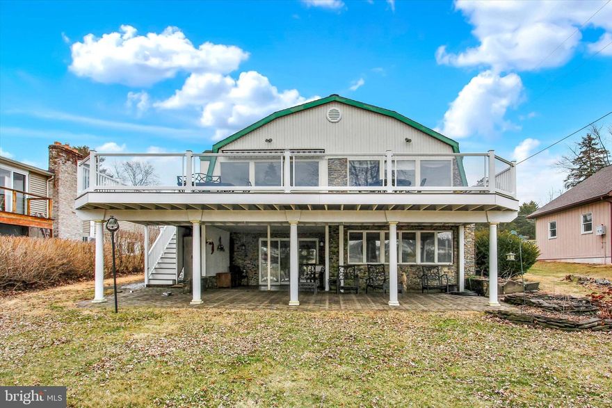 It's hard to find such a beautifully move-in ready lakefront home in sought-after Lake Heritage!  Even the furniture is available for sale.  This open floorplan, 3075 sqft, 3 bedroom/2.5 bath, rancher with full finished walk-out basement has great sunset lakeviews from kitchen, dining area, living area, sunroom, as well as lower level bedroom and family rooms.  Main level has all wood flooring and includes kitchen with Silestone counters and an island, dining area that leads right into the living room with floor-to-ceiling stonefront fireplace with pellet stove insert, sunroom, a large bedroom and tiled full bath (with heated floor!).  Lower level has owner's suite with gorgeous on-suite bath, 3rd bedroom, family room with 2nd pellet stove, and laundry room (check out the built-in wall safe).  Rear composite deck with electric awning makes for low maintenance living. Lower level below-deck party patio provides cover for shade lovers. And deck boasts and electric boat lift. Propane powered Generac generator also included.  Chris Craft ski boat and 2007 sun chaser 18 foot pontoon boat available for sale. Lake Heritqge, conveniently located just off Rts 15 and 97 for easy access, includes a 150 acre lake for water skiing, fishing, boating of all kinds, olympic-sized pool right on the lake, community center, playgrounds, pavilions, dog parks, walking trail, basketball court, beach volleyball, tennis/pickleball court, clubs and more.