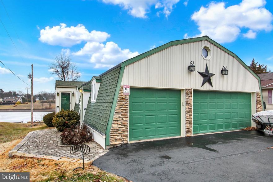 It's hard to find such a beautifully move-in ready lakefront home in sought-after Lake Heritage!  Even the furniture is available for sale.  This open floorplan, 3075 sqft, 3 bedroom/2.5 bath, rancher with full finished walk-out basement has great sunset lakeviews from kitchen, dining area, living area, sunroom, as well as lower level bedroom and family rooms.  Main level has all wood flooring and includes kitchen with Silestone counters and an island, dining area that leads right into the living room with floor-to-ceiling stonefront fireplace with pellet stove insert, sunroom, a large bedroom and tiled full bath (with heated floor!).  Lower level has owner's suite with gorgeous on-suite bath, 3rd bedroom, family room with 2nd pellet stove, and laundry room (check out the built-in wall safe).  Rear composite deck with electric awning makes for low maintenance living. Lower level below-deck party patio provides cover for shade lovers. And deck boasts and electric boat lift. Propane powered Generac generator also included.  Chris Craft ski boat available for sale. Lake Heritqge, conveniently located just off Rts 15 and 97 for easy access, includes a 150 acre lake for water skiing, fishing, boating of all kinds, olympic-sized pool right on the lake, community center, playgrounds, pavilions, dog parks, walking trail, basketball court, beach volleyball, tennis/pickleball court, clubs and more.