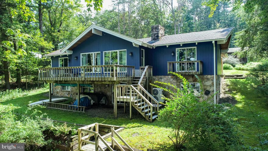 Charming Lake Front Craftsman at Deep Creek Lake - Private, wooded, and nearly an acre, this waterfront property delivers rare seclusion with a clean, gentle slope into deep water. Private Type-A dock with over 100’ of lakefront. Located just off Boyscout Rd, this home is positioned forward on the lot to maximize open-water views while maintaining a natural tree line for cover. A full-length deck spans the back with clear sightlines across the lake. Inside, exposed timber beams, cedar panels, and an open floor plan connect the living space to its surroundings, while a finished walk-out level adds flexible room for hosting or relaxing without crowding the main floor. Well-maintained with plenty of opportunity to add your personal touch. Don’t miss your chance to own an amazing piece of Deep Creek Lake – call today to book a private showing!