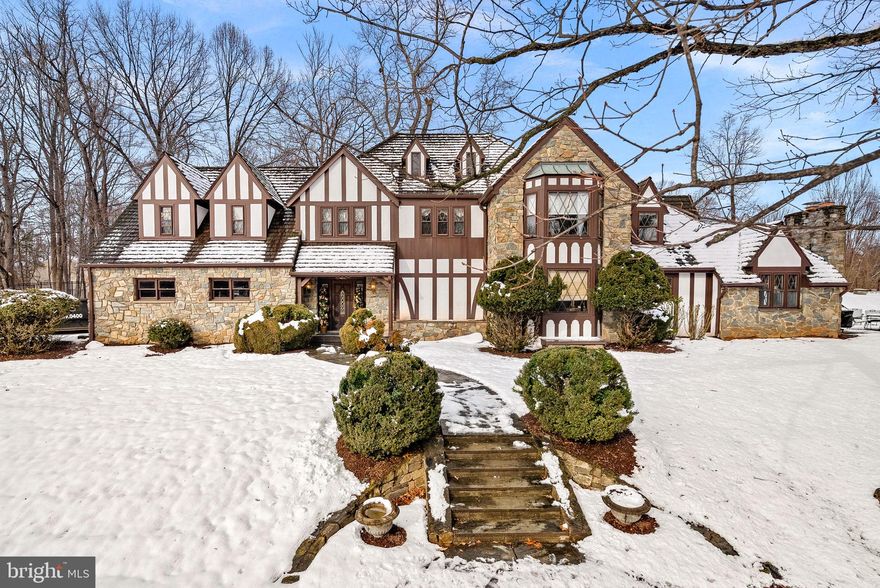 Perched high on a hill in the heart of Great Falls, this iconic Tudor residence is offered for the first time in 45 years. Set on 2+ private acres, the property combines timeless architecture with thoughtfully updated living spaces.

Distinctive design elements include steeply pitched rooflines, decorative half-timbering, leaded glass accents, and rich stucco detailing — all complemented by interior stone walls, multiple fireplaces and long center hallways.  

The home features 5 bedrooms, 3 full baths, and 3 half baths, with hardwood floors throughout the main level. The expanded kitchen is designed for both everyday living and entertaining, showcasing a large granite island, stainless steel appliances, abundant cabinetry and a cozy gas fireplace.  

The spacious primary suite offers a tray ceiling, three closets, and a private sitting room. The en-suite bath includes a walk-in shower, jetted soaking tub, separate bidet, and generous vanity space.

Recent updates include a newer Trane HVAC system and hot water heater, along with the added benefit of a whole-house generator for peace of mind. Mature landscaping provides exceptional tranquility while remaining close to all that Great Falls has to offer and less than 2 miles from Route 7 making commuting a breeze.  

From its timeless Tudor architecture to the incredible hilltop setting, this home is truly magical. The kind of property where memories are made, adventures are imagined, and every room tells a story.  A rare opportunity to own a truly special and well-appointed home in one of Northern Virginia’s most sought-after communities.