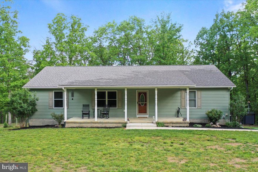 This isn’t just a house—it’s a legacy built to last. Tucked away in the quiet Parker Knolls Subdivision on 8.876 wooded acres, this custom rancher sits right on the Hampshire County line, offering serious seclusion without putting you hours off the grid. Built by one of the area’s most respected builders, this place was made to stand the test of time. You’re just an hour from Winchester and two from Baltimore or D.C.—close enough to stay connected, far enough to finally exhale. With more than 3,000 square feet of total living space, this home delivers room to spread out and live how you want. The main level features three bedrooms, two full baths, and a country kitchen built for real-life gatherings—not just showpieces. Downstairs, the finished walk-out basement brings two more bedrooms, a full bath, a family room or office space, and a second full kitchen—perfect for guests, in-laws, or setting up a separate living area.
Stay comfortable year-round with a heat pump and central air—or fire up the outdoor wood furnace if you prefer to do things your own way. Outside, a 200-square-foot insulated workshop with electric is ready for your tools or weekend projects, and a 540-square-foot detached garage with overhead door keeps your truck, equipment, and gear under cover. Whether you're on the front porch with a hot cup of coffee, out back on the deck, or grilling on the patio, you're surrounded by peace and privacy. The nearly nine wooded acres are full of wildlife—deer, turkey, and everything in between. Whether you hunt, hike, or just watch the woods come alive, this land pulls its weight. If you’re looking for space, privacy, and a place that feels like yours the second you pull in, this one’s worth a look. Places like this don’t show up every day.