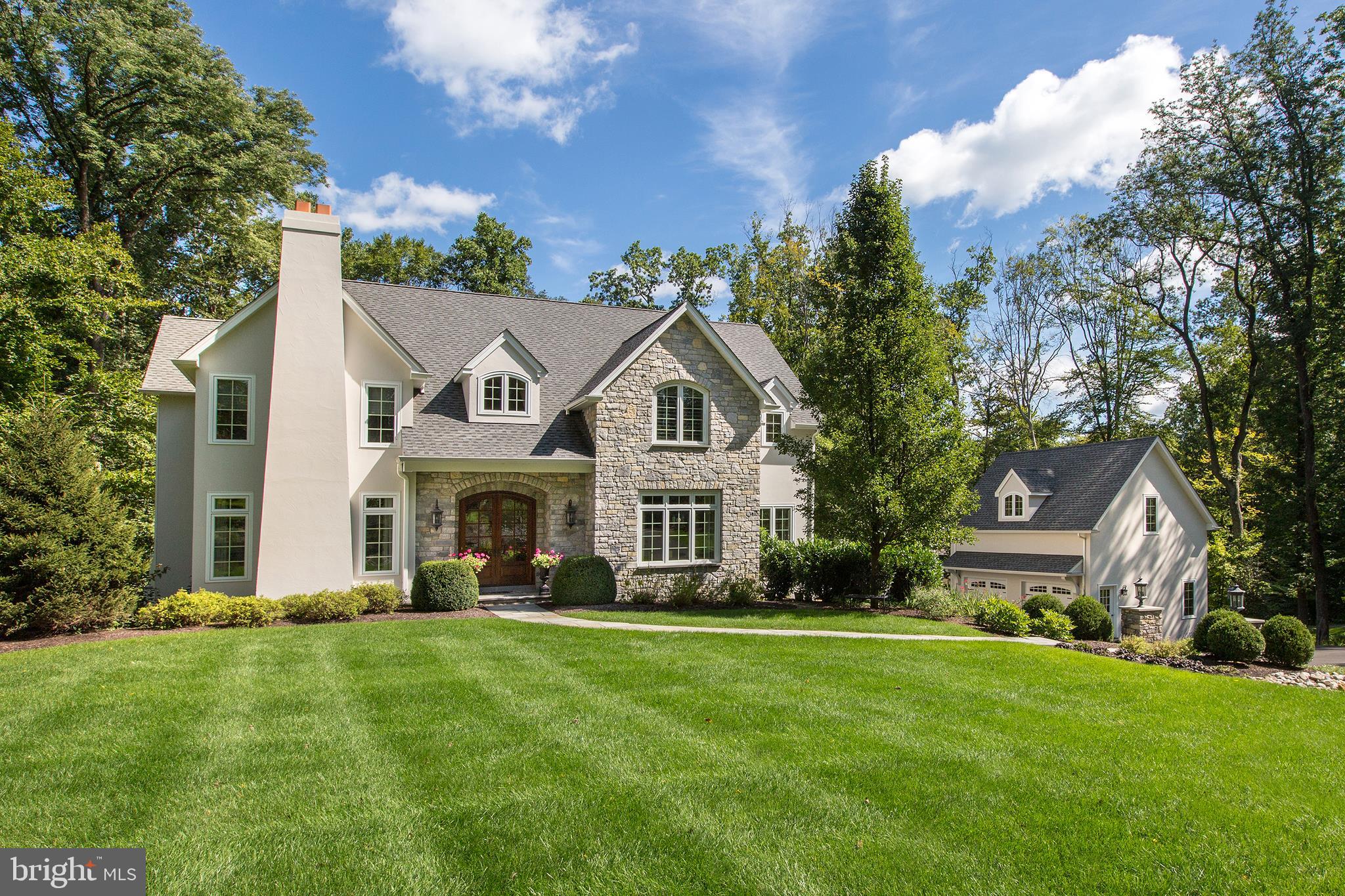 This beautifully appointed 4-5 Bedroom, 3.1 bath custom-built home is situated on a part-wooded 3.84 acre property, offering 3 levels of finished living space, 3 fireplaces & numerous venues for entertaining, both indoors & outdoors! The property boasts upper & lower patios, a comfortable screened porch, heated salt water pool, & hot tub. A double front door entry w/arched design leads to the center foyer, w/turned staircase & wrought iron spindles, & flanked by a home office & custom built-ins, & an inviting living room with marble fireplace. Behind is a gracious dining room w/French doors to the outside upper terrace equipped w/a grill! The stunning chef's kitchen & breakfast area has French doors to the terrace beyond. The kitchen is outfitted w/antiqued light glazed cabinetry, granite counters & bar sink, sitting bar w/"Grothouse" cherry top, & large pantry; quality appliances incl.a Subzero Refrigerator w/ freezer drawers, 2 dishwashers (Miele & Bosch),full-sized wine cooler, Wolf 5-burner gas cook top, stainless double ovens, built-in microwave & deep porcelain farm sink. The step-down Great Room w/cathedral ceiling showcases a cast limestone fireplace, b/in cabinetry & French doors to the outside. A large powder room w/specialty vanity & full laundry w/deep stainless sink & Whirlpool washer & dryer, each are each privately tucked away. Upstairs, the luxurious main bedroom suite is outfitted w/custom carpeting, a sitting/study area, & plantation shutters. 2 large walk-in closets have closet systems; steps lead to the en-suite bath, w/two vanities w/onyx counters, jetted tub, & oversized steam shower. Two nicely sized corner bedrooms, one w/a fireplace, & a multi-use spare room (nursery,craft,yoga,bedroom) share a spacious hallway bath w/tub, w/linen closet & secondary laundry w/Bosch stack washer/dryer! The lower level boasts a large media/game room w/custom carpeting, and access to the welcoming screened porch. Also, a lower level bedroom offers a true daylight experience, w/a full bath nearby-a bath for the bedroom and a changing room for the pool. An attached 2-car garage is accessible through the lower level foyer, along with a mechanical room. Across the driveway, there is a 2-car detached garage with full finished 2nd floor with skylights, wood floors, ceiling fan and TV- ready for use as a home office or gym! Special features incl. propane heat, central vac, central security, lawn irrigation, electric gutter heating unit on upper terrace,a back-up generator, professional landscaping, two dishwashers, two laundries, & quality and pride of ownership throughout!