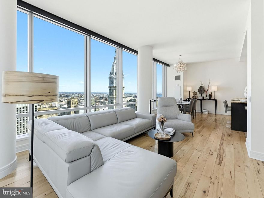 Perched on the 32nd floor, this sought-after 2-bedroom, 2.5-bath corner residence offers approximately 1,645 square feet and sweeping wraparound views of Dilworth Park, City Hall, William Penn, and the Delaware River.

There’s a point in the building where the experience shifts.

At this elevation, the city doesn’t disappear- it settles.
The movement is still there, but it feels quieter. More intentional.

From here, the light moves differently. Mornings arrive clean. Evenings stretch a little longer. And as the city transitions into night, the skyline becomes something else entirely, layers of light, movement, and reflection that carry through every room.

The layout is designed with intention. A proper foyer entry leads into a wide living area with a defined dining space, all oriented toward the glass. With 9+ foot ceilings and expansive floor-to-ceiling windows, the connection to the skyline becomes part of your daily rhythm.

The kitchen balances function and presence. Outfitted with Viking, Sub-Zero, and Miele appliances, it includes an island, dining area, butler’s pantry, and generous storage integrated in a way that supports both everyday living and hosting with ease.

The primary suite is well-proportioned and grounded, featuring a walk-in closet and a marble bath with double sinks, soaking tub, and glass-enclosed shower. A space designed for comfort without excess.

The second bedroom is well-proportioned, with a floor-to-ceiling window and a private en-suite bath—comfortable, bright, and thoughtfully separated.

What stands out is how well the home has been maintained. Clean, carefully kept, and consistent over time.

Residents enjoy full-service living with a 24-hour concierge and doorman, chauffeur service, fitness center with lap pool, hot tub, and yoga room, along with a residents’ lounge, media room, outdoor terrace, and private landscaped park. The Ritz-Carlton Residences Association fees include many utilities and services, adding ease to ownership.

Located along the Avenue of the Arts in the heart of Center City, with direct access to dining, theaters, transit, and cultural destinations.

Some will see this as a primary home that simplifies daily living.
Others will recognize it as a long-term hold in a location that continues to anchor value.

Either way, it’s not trying to impress.
It’s designed to last.