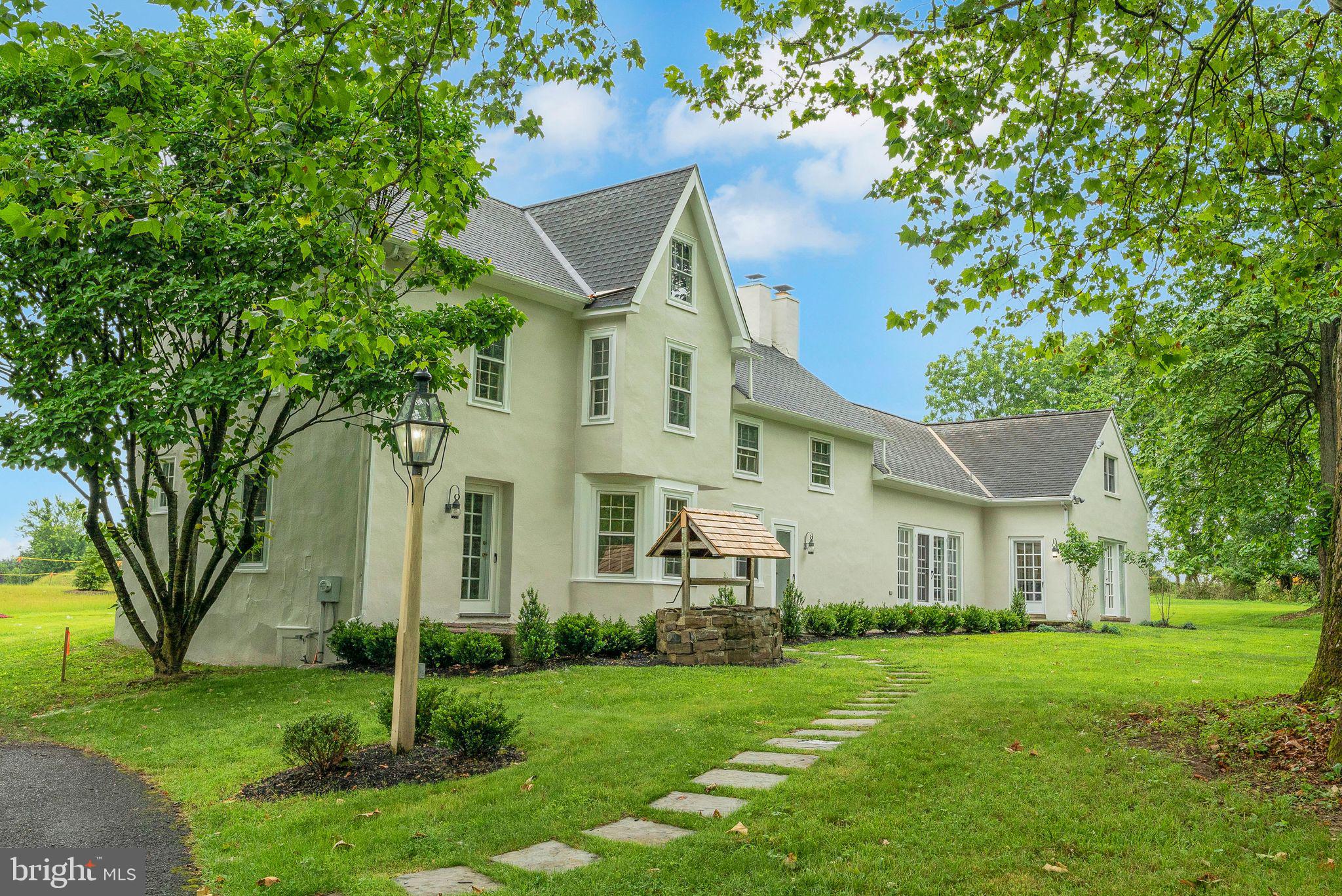 Stately 1800's Farmhouse on nearly 2.5 acres of gorgeous grounds in beautiful Warrington, Central Bucks County! Enter the impressive property via a long tree lined driveway alongside a beautiful pond and imagine coming home to this peaceful place every day. Inside the front door is a spacious entry room with pine planked floor and original solid oak pocket doors. To the right, through the pocket doors, leads to the living room/library with fireplace and straight ahead are stairs to the second floor. Beyond the living room is a dining room, followed by the kitchen, family room, and main level bedroom. The main level bedroom offers flexibility for multi-generational living or guest accommodation with its private entrance and full bath. The kitchen includes a wood burning fireplace with French doors providing great natural light and gorgeous views of the pond with access to the patio and grounds. The kitchen also includes a second set of stairs providing access to the second floor. Upstairs is a large owner’s suite with sitting room, and owner’s bathroom. The remainder of the second floor has two bedrooms and two bathrooms. The third floor is completely empty and waiting to be finished space. Wander outside along the beautiful patio overlooking the pond and ample tree lined grounds. This unique property is in top rated Central Bucks School District and is ideally situated just minutes from downtown Doylestown. This home offers quick access to charming shops, award-winning restaurants, museums, and community events. It’s also conveniently close to Delaware Valley University, Doylestown Hospital, the Doylestown bike and hike trail, and the scenic Peace Valley Park and Nature Center — perfect for nature lovers and outdoor enthusiasts. Elementary, Middle, and High School are all just minutes away. Commuters will appreciate the easy access to major routes and nearby SEPTA regional rail service, making travel to Philadelphia and beyond a breeze. This unique home is a rare blend of historic charm, modern updates, and prime location. The property is being sold "as is” and is awaiting your final touches.