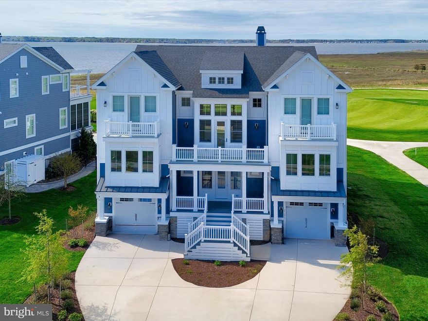 An Elevated Coastal Sanctuary in The Peninsula - Welcome to 27686 Sterling Boulevard, an Echelon-built, The Anegada is a masterpiece nestled in the prestigious Sanctuary section of The Peninsula on the Indian River Bay. This custom luxury home offers a rare fusion of coastal sophistication, smart innovation, and sweeping waterfront panoramas—designed for the discerning buyer who craves both beauty and function. Perched on a premium lot overlooking the 7th green, this stunning residence boasts unobstructed views of the Indian River Bay, the Inlet, and the lush fairways beyond. Every inch of this property has been thoughtfully crafted for effortless living and entertaining, all within one of Delaware’s most amenity-rich gated resort communities. 

Inside, the home unfolds with an open-concept design that highlights the surrounding landscape at every turn. Wide-plank Glacier Oak flooring flows throughout, complementing fresh interior and exterior paint, solid-core doors, and designer details like custom board and batten millwork. The bright and welcoming foyer opens to an expansive living room anchored by a floor-to-ceiling gas fireplace and flanked by glass doors that spill onto a generous patio—perfect for taking in the bay breezes and watching golfers play through. At the heart of the home is a gourmet kitchen built to impress, featuring 42-inch custom soft-close cabinetry with under-cabinet lighting, Quartz countertops, pull-out shelving, and a professional-grade Monogram stainless steel appliance suite, including a six-burner gas cooktop. The oversized island with breakfast bar invites casual conversation or a morning cup of coffee. An adjacent dining and sitting area flows effortlessly to the screened porch, ideal for outdoor entertaining with a spectacular natural backdrop. The main-level primary suite is a retreat unto itself, offering two custom walk-in closets, a spa-inspired bath with dual vanities, soaking tub, and frameless glass shower. A nearby flex room serves perfectly as a home office—ideal for a quick email check before hitting the greens. Upstairs, a spacious loft takes center stage for relaxed gatherings, with another screened porch to enjoy sunrise views. Three guest suites, each with private ensuites and access to either a balcony or covered outdoor living space, provide comfort and privacy for visitors. The finished lower level is an entertainer’s dream with a custom wet bar, wine fridge, built-ins, and a sprawling recreation room perfect for movie nights or game-day festivities. A bonus flex room and full bath offer versatility, while two garages with epoxy floors and custom built-ins deliver abundant storage and a clean, modern finish.
Technologically advanced yet effortlessly inviting, the home is outfitted with a Control4 Smart Home system that manages lighting, temperature, sound, window treatments, garage doors, and security all from your smartphone. A fully integrated ADT security system with four exterior cameras provides peace of mind, while owned solar panels and SRECs keep energy costs remarkably low. Hunter Douglas room-darkening shades and Sonos speakers are installed throughout, and the home is elevator-ready for added convenience. The invisible fence and pool-approved lot complete this perfect picture of luxury living.
As a resident of The Peninsula, you'll enjoy world-class amenities including a private Jack Nicklaus Signature golf course, indoor and outdoor pools (including a wave pool and adults-only oasis), full-service spa, state-of-the-art fitness center, tennis, basketball, mini golf, and a private bay beach with kayak and paddleboard rentals. Nature lovers will appreciate the miles of walking trails, fishing pier, and Audubon-certified nature preserve.
A breathtaking home in an extraordinary community—this is coastal resort living redefined.