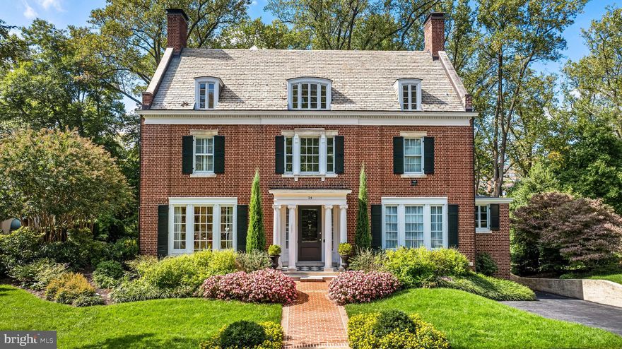 Designed by renowned Baltimore architect Laurence Hall Fowler, 24 Whitfield Road is a beautifully updated all brick Federal style home, easily one of the most beautiful homes on a street of very fine residences. The classic Ionic portico welcomes visitors to the gracious Foyer with sweeping staircase and French doors to the Living Room, Dining Room and Den. The formal Living Room with fireplace and floor-length windows lead to the covered porch and patio. The Den features built-in bookcases and also leads to the patio. The elegant formal Dining Room with fireplace and fully equipped Butler's Pantry/Catering Kitchen flows to custom gourmet Kitchen surrounded by  3 walls of windows with marble floor and counters and French doors opening to the patio. A sumptuous Primary Suite with fireplace, extensive custom-fitted Dressing Room, marble Bath and private Sunroom overlooking the back yard. 2 additional large Bedrooms, one also with a private Sunroom, and Hall Bath complete the 2nd level. 2 Bedrooms, the largest perfect as an office, 2 Baths and a cedar-lined storage room are found on the 3rd level. An open oak staircase leads to a new, masterfully designed lower level that includes a Family Room with fireplace and wet bar, wine storage room, Laundry Room, Half-Bath and Utility/Storage Room. A level walk-out from the Family Room gives access to the Garage and a stone patio. Perfect for entertaining or alfresco dining, a stunning black and white ceramic tiled patio and covered porch sweep across the back of the house with beautiful elevated views of the double lot and Linkwood park beyond. Set within professionally landscaped gardens is this wonderful home, perfect inside and out. 24 Whitfield Rd is comprised of two separate parcels. The main house parcel of .519 acre is tax i.d. 0327134970A011. The adjacent parcel of .336 acre facing Linkwood Rd is tax i.d. 0327134970A026.