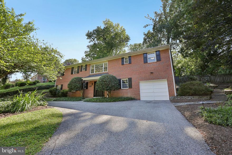 This elegant all-brick raised ranch in the coveted Rollingwood neighborhood of Chevy Chase offers 3,100 square feet of beautifully designed living space across two levels. The home has been well maintained and thoughtfully laid out to provide both comfort and flexibility. The lower level welcomes you with a spacious recreation room featuring a wet bar, along with a bedroom, full bath, utility and laundry rooms, and direct garage access. Upstairs, abundant natural light pours across hardwood floors, highlighting a seamless flow between the living and dining areas. The kitchen connects effortlessly to a sunroom that opens onto a professionally landscaped, low maintenance, and expansive backyard, perfect for enjoying the outdoors in every season. Two additional bedrooms and two full baths complete the upper level, creating inviting retreats with a sense of balance and privacy. The setting is just as appealing as the home itself. Residents enjoy close proximity to Rock Creek Park and its extensive trail system, offering miles of pathways for walking, running, or biking. Commuters benefit from easy access to the Beltway, downtown Bethesda, Silver Spring, and Washington, D.C., while nearby Metro stations provide further convenience. Parks, playgrounds, Meadowbrook Stables, and Meadowbrook Local Park are only minutes away, and a short drive leads to Bethesda Row with its mix of boutiques, dining, and entertainment. Combining classic architecture with sun-filled interiors and a coveted location, this home delivers a lifestyle that is both refined and connected, offering the perfect blend of indoor comfort and outdoor enjoyment.