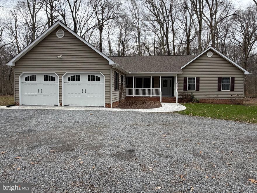 Nestled on a serene 5.64-acre lot, this charming ranch-style home offers a perfect blend of comfort and modern living in a tranquil rural setting. Built in 2003, this well-maintained residence boasts 2,100 square feet of thoughtfully designed space, featuring three spacious bedrooms and two full bathrooms, ideal for relaxation and everyday living. Step inside to discover a warm and inviting interior adorned with a mix of hardwood, carpet, and vinyl flooring. The heart of the home is the eat-in kitchen, complete with upgraded countertops, stainless steel appliances, and an island with additional storage. The formal dining room provides an comfortable space for gatherings, while the cozy living areas are enhanced by recessed lighting and ceiling fans, ensuring a comfortable atmosphere year-round. The exterior of the property is equally impressive, featuring a deck perfect for outdoor entertaining and a hot tub for unwinding under the stars. The beautifully landscaped front and rear yards are surrounded by mature trees, offering privacy and a picturesque view of the woods. Additional structures include a detached garage providing ample storage and workspace. Located in a peaceful rural community, this home offers the best of both worlds-seclusion and accessibility. Enjoy the benefits of nearby parks and recreational areas, perfect for outdoor enthusiasts.  Public services are readily available, ensuring convenience and peace of mind. With a private, no-thru street, this property offers a safe and quiet retreat while still being within reach of essential amenities. Whether you're looking to enjoy the tranquility of nature or engage with the community, this home is a perfect choice for those seeking comfort and connection. Come experience the warmth and charm of this delightful property.