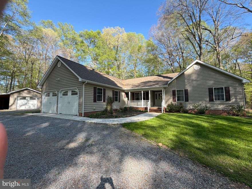 Nestled on a serene 5.64-acre lot, this charming ranch-style home offers a perfect blend of comfort and modern living in a tranquil rural setting. Built in 2003, (New Roof in January 2026!)  this well-maintained residence boasts 2,100 square feet of thoughtfully designed space, featuring three spacious bedrooms and two full bathrooms, ideal for relaxation and everyday living. Step inside to discover a warm and inviting interior adorned with a mix of hardwood, carpet, and vinyl flooring. The heart of the home is the eat-in kitchen, complete with upgraded countertops, stainless steel appliances, and an island with additional storage. The formal dining room provides an comfortable space for gatherings, while the cozy living areas are enhanced by recessed lighting and ceiling fans, ensuring a comfortable atmosphere year-round. The exterior of the property is equally impressive, featuring a deck perfect for outdoor entertaining and a hot tub for unwinding under the stars. The beautifully landscaped front and rear yards are surrounded by mature trees, offering privacy and a picturesque view of the woods. Additional structures include a detached garage providing ample storage and workspace. Located in a peaceful rural community, this home offers the best of both worlds-seclusion and accessibility. Enjoy the benefits of nearby parks and recreational areas, perfect for outdoor enthusiasts.  Public services are readily available, ensuring convenience and peace of mind. With a private, no-thru street, this property offers a safe and quiet retreat while still being within reach of essential amenities. Whether you're looking to enjoy the tranquility of nature or engage with the community, this home is a perfect choice for those seeking comfort and connection. Come experience the warmth and charm of this delightful property.