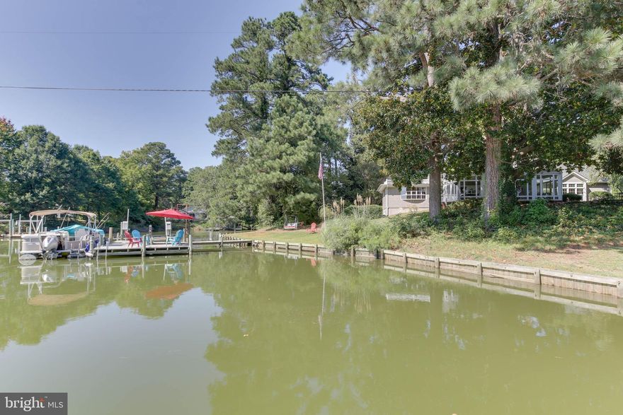 THIS WATERFRONT BEAUTY HAS JUST BEEN "REFRESHED" AND IS READY FOR ITS NEW  OWNER! Enjoy water views from nearly EVERY room in this restful, river retreat. A 1940's Fisherman's Gable home that has been thoughtfully expanded several times to accommodate even the largest of gatherings while still creating a private, cozy, intimate environment. Venture down the driveway to the beautiful, peaceful and private surroundings-including some of the largest Magnolia trees in the county. Upon entry be greeted by a Stunning Living/Dining Room with beautifully crafted bookshelves and moldings.  This room could be used in a number of ways. Having both a Family Room and Den allows for those with different TV taste to spread out-and both rooms have Glass French Door access to the All Glass River Room. The River Room, the unanimous favorite space. All Glass with PERFECT Water Views AND 2 Mitsubishi Mini-Split Heat Pumps for A/C and Heat. The Large Private Primary Bedroom also features Water Views from the Oversized Curved Bay Window to the windows flanking the bed AND Water Views from the Jetted Tub in the Primary Bath. The Kitchen is EXPANSIVE-lots of room to hang out and create a wonderful meal: Water views here too. The back Bedroom Suite includes 2 bedrooms and a sitting room all with access to the Full Bath. Venture upstairs to this charming space that kids and adults will both love. Ideal overflow space with 2 rooms and a Full Bath. Combine this beautiful home with a quaint potting shed, oversized 2 car garage with unfinished upstairs/storage, Dock with Boat Lift, Easy access to the Chesapeake Bay, high-speed internet(perfect for WFH) and a Brand New Roof. Offering a 1-yr Cinch Home Warranty.  Home is NOT in a Flood Zone. Owner/Agent.
