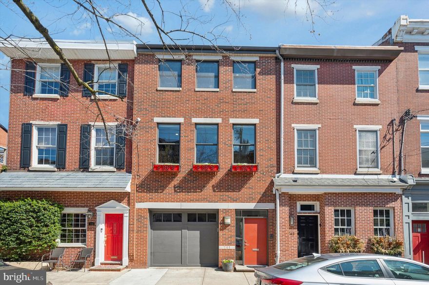 Welcome to this meticulously and custom crafted Queen Village 3 bed, 3.5 bath stunner, designed by Meera Thomas! The wide-open first floor sets the stage for effortless entertaining. Enter into the foyer with a powder room and indoor access to the garage. Continue into your chef's kitchen with top of the line appliances including wine fridge, hand crafted custom cabinets, waterfall island with stone counter with modular sink work-station, tons of display and storage space, unique extendable dining table (seats up to 10!) and hidden outlets for a multi-use modern charging station for your convenience. The level is completed with a cozy den and shelves designed perfect for this space for your entertaining needs, and with large glass doors, looks out and can open up to the main floor garden courtyard designed by Nicholas Patrick with stone flooring and lots of room for relaxing, entertaining, and gardening. 
The stairs take you up to a huge additional living room with huge windows and ample natural light. Down the hall of sleek closets, find a large primary suite that overlooks the garden. The third floor has two bedrooms both with en suite bathrooms, laundry room, and tons of storage space. Up another flight you'll find a nice landing with more storage and a pilot house leading to a fantastic roof deck with incredible 360* views of the city.  An irrigation system ensures the lush greenery adorning the roof and front window boxes remains vibrant year-round.
The basement is fully finished with a dedicated fitness area and home office with more custom cabinetry and extra storage. A spacious mechanical room completes this level. 
Whether you're hosting soirées in the spacious living areas, enjoying a quiet evening on the patio, or taking in the city lights from the roof deck, this home offers unparalleled opportunities for relaxation and entertainment. This arguably most sought after niche of Queen Village is in the high ranking Meredith School catchment, and walkable to a multitude of parks, shops, restaurants and cafes, historical sites and also the exciting Penn's Landing waterfront with year round events and attractions.