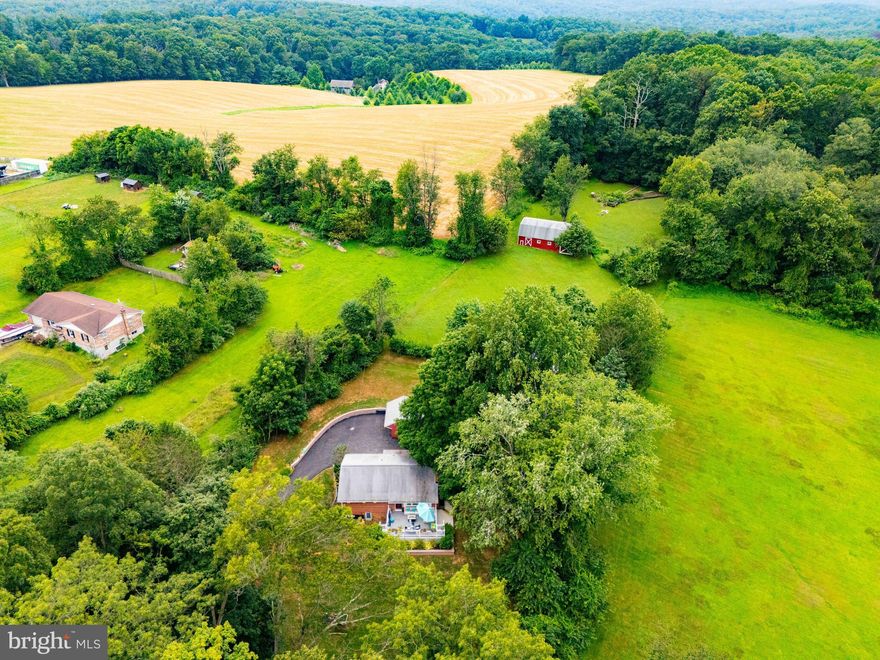 Welcome to 2317 Bulls Sawmill Rd in Freeland — a beautiful rancher nestled on over 2 acres of peaceful countryside. This property offers the perfect blend of comfort, charm, and functionality. Step inside to find an updated kitchen with quartz countertops and a cozy breakfast area. The inviting living room features a wood-burning fireplace, while the main level full bath has been tastefully updated. The finished basement expands your living space with a spacious rec room with electric fireplace, a 4th bedroom with egress window, and a second updated full bath.  Outdoor living is a dream here — relax on the spacious Trex deck overlooking the front yard, or enjoy gatherings in the backyard on the patio with firepit. Bring your horses and make use of the barn with 3 stalls. The property also includes a detached 2-car garage, an oversized 2-car pole barn, and an above-ground pool for summer fun. With a peaceful setting, this home won’t last long. Don’t miss your chance to own this slice of country paradise!