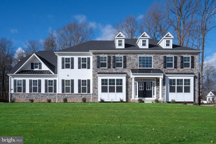 QUICK DELIVERY AVAILABLE WINTER 2025/2026!! Framing and mechanicals are now complete, it's the perfect time to schedule a tour and witness the progress first hand. Crafted with the precision and sophistication of Hallmark Homes Group, this home has been curated and upgraded with the finest materials to deliver an unparalleled living experience. The main level boasts ten-foot ceilings and an impressive two-story great room with an expansive wall of glass overlooking the rear yard. The home is meticulously appointed with hardwood floors, custom millwork, solid-core doors, box-tray and coffered ceilings to create an elevated aesthetic appeal.  The kitchen is a chef's dream, featuring a custom Village Handcrafted Cabinetry layout, Sub-Zero and Wolf appliances, and quartz countertops. The main level is completed by a mudroom with cubbies, a laundry room including sink and custom cabinetry, two powder rooms, and an in-law suite complete with full bath and walk-in closet. The Owner's Suite provides a haven of tranquility with a boxed tray ceiling, multiple large walk-in closets, an expansive private office, and a spa inspired ensuite bathroom with free-standing tub and large walk-in shower with frameless shower doors. The finished basement level includes a full bathroom, main entertaining area, large playroom with double doors, and walk-up steps to the back yard. A spacious four-car garage ensures convenience for your luxury automobile collection. Equipped with a smart home package including wiring for smart TVs, WiFi network, and home security for an integrated living experience.  Located on the edge of the Gwynedd Valley within the esteemed Wissahickon School District, this exclusive property enjoys close proximity to prestigious private schools, the Gwynedd Valley and Ambler train stations, easy access to 309 and the PA Turnpike, and just minutes from the shopping and dining of downtown Ambler and the upscale amenities of Springhouse Village, including Whole Foods and Starbucks. Schedule a tour today while there is still time to select cabinet colors and other finishes before it is too late!