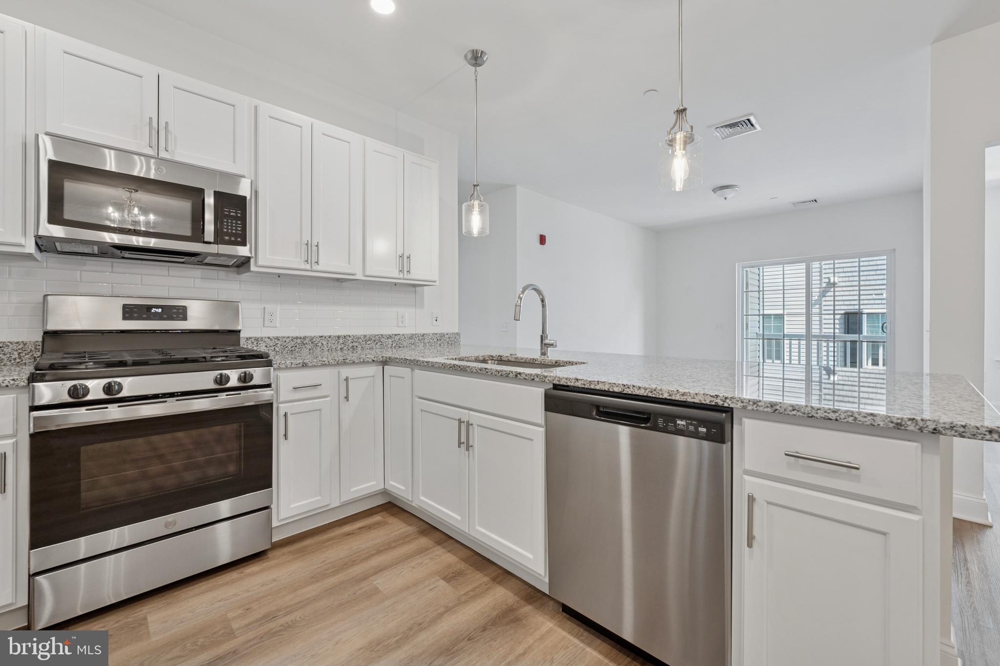 This 2 year new, Residences at Brookhaven Glen condo has no long hallways to travel as each floor has only 4 condos. Every unit is a corner with lots of windows for so much natural light. This unit has a partial courtyard view from the lovely balcony, and the entry is just steps away from the main entry (secured with key fob),. An elevator will take you to this 2nd-floor unit (or you can take the steps in a well-lit, wide and spacious hallway), where a lovely open floor plan and 9' dramatic ceilings greet you. A gorgeous, upgraded kitchen boasts white cabinets, beautiful granite countertops, upgraded faucet, pantry, Progress pendant lighting over the sink/breakfast bar, a stainless steel undermount sink and stainless steel appliances (dishwasher, microwave, refrigerator) are included! The kitchen with it's gracious breakfast bar is wide open the to the dining area (with crown molding and chair rail) and the living room which has sliding glass doors leading to a lovely balcony with partial view of the beautiful courtyard. (A storage closet is also located on the balcony). The front room can serve as a bedroom or den, office, gym, etc., and there are 2 more bedrooms to the back of the condo. The primary bedroom is spacious, has a large walk-in closet and a beautiful full bath with shower, double bowl vanity with granite countertops and a convenient linen closet too. The other bedroom is spacious, has a double closet, and is adjacent to another full, hall bath, also with granite countertops and a shower. All bedrooms have upgraded lighted ceiling fans as well, there are raised-panel doors throughout the unit with custom hardware, luxury vinyl plank flooring throughout the entire home. The convenient in-unit, full-size washer and dryer are located in the hallway and are also included. Dont miss the gorgeous courtyard in the rear of the building which includes 2 pergolas, 2 gas grills, a small fountain and a gazebo with rocking chairs for all to enjoy. There is also a private dog park too. Come see! You will not be disappointed! (Conveniently located just minutes from I-95, Route 1, the Blue Route, Media Boro, the airport and lots of shopping and restaurants!)