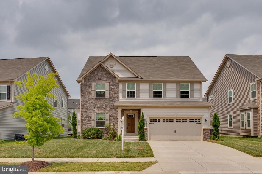 Located in the desirable Fieldside subdivision, this fantastic four-year-old colonial stands out as one of the largest models in the neighborhood. With its attractive stone front and covered front porch, this home offers great curb appeal. Upon entering through the front door, you are greeted by a formal dining room and living room.  The heart of the home is the large open island kitchen, complete with a breakfast bar for four chairs. The kitchen boasts granite countertops, stainless steel appliances and a stylish designer glass tile backsplash. Additionally, the kitchen features 42-inch cabinets, recessed lights, and a morning room addition that floods the space with natural light, thanks to its abundance of windows. The morning room also offers a cathedral ceiling and a ceiling fan, and it provides convenient access to a future deck. The open floor plan seamlessly connects the kitchen to the large open family room, which features a gas fireplace with a mantle and slate surround. The upgraded LED light package enhances the overall ambiance. Adjacent to the family room, you'll find a main level office, perfect for those who work from home. A spacious pantry off the kitchen provides additional storage space. Moving to the upper level, you'll discover a generously sized owner's suite that exudes elegance with its designer tray ceiling, crown molding, and ceiling fan. The suite also includes a comfortable sitting room area and a large walk-in closet. The owner's suite bathroom is equally impressive, featuring raised double sinks, an oversized soaking tub with a ceramic tile surround, a separate shower with a built-in bench, a second walk-in closet, and a private commode area. A full bathroom is conveniently located in the hallway, serving the three large guest bedrooms. There's also a second family room area on this level, providing a cozy space for relaxation. The upper level laundry room comes equipped with a full-size washer and dryer. The full finished basement offers even more living space, with a large open recreation room that features recessed lighting. Additionally, there is a theater room and a full bathroom in the basement.  The utility room houses the gas furnace, sub pump, and instant hot water systems.
 Completing the property is a two-car garage with an automatic garage door opener. With its impressive features, spacious layout, and stylish finishes, this colonial home offers a comfortable and inviting living experience.