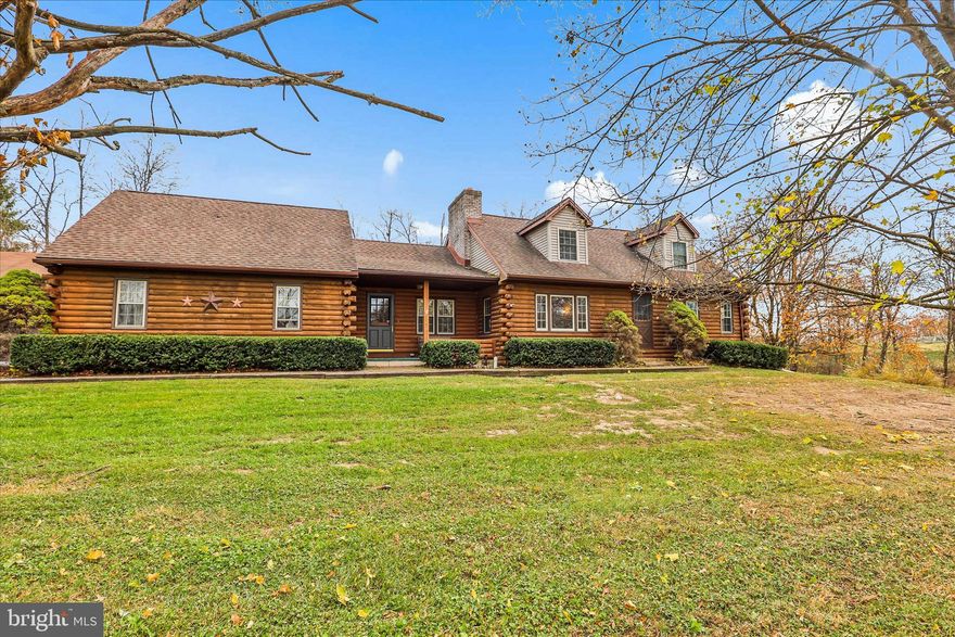 Welcome to your country retreat! This beautiful log cabin–style home sits on 4.44 private acres and features 3 to 4 bedrooms and 2 full baths, including a private second-floor oversized primary suite with electric fireplace. The kitchen and dining area boasts a cathedral ceiling and a wood-burning fireplace, while the family room showcases exposed wood beams and another wood-burning fireplace.  Enjoy plenty of garage space with an attached 2-car garage plus a 3-car detached garage offering even more space for storage or a workshop. Experience the perfect blend of rustic character, comfort, and privacy—all in a peaceful country setting close to local conveniences.