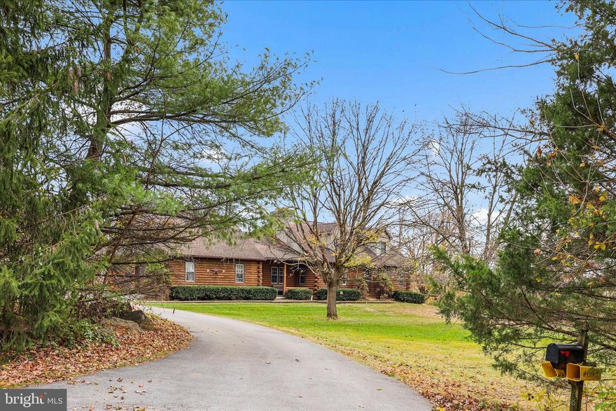 Welcome to your country retreat! This beautiful log cabin–style home sits on 4.44 private acres and features 3 to 4 bedrooms and 2 full baths, including a private second-floor oversized primary suite with electric fireplace. The kitchen and dining area boasts a cathedral ceiling and a wood-burning fireplace, while the family room showcases exposed wood beams and another wood-burning fireplace.  Enjoy plenty of garage space with an attached 2-car garage plus a 3-car detached garage offering even more space for storage or a workshop. Experience the perfect blend of rustic character, comfort, and privacy—all in a peaceful country setting close to local conveniences.