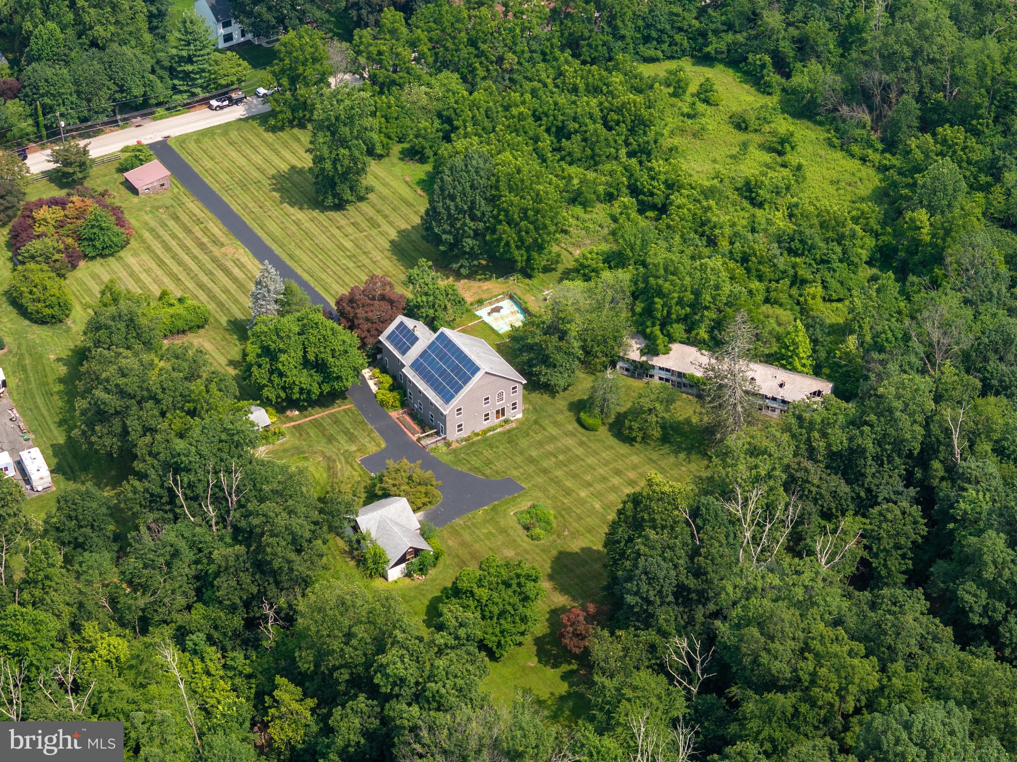Stunning rare 8-acre sanctuary next to Evansburg State Park with 3300 acres and just minutes from major amenities, yet worlds away in peace and privacy. This extraordinary off-grid-ready property offers a harmonious blend of nature, sustainability, and thoughtful design. Horse stalls, a detached office building, and subdivision potential truly set this property apart.
At the heart of the property is a spacious 2-level home with over 3,500 square feet of living space, seamlessly combining rustic charm and modern convenience. The original 900 sq ft pine-paneled cottage, rich with character, was beautifully expanded in 2012 with a 2,400 sq ft custom-built addition featuring 2x6 construction, spray foam insulation, Red Oak hardwood floors, 9-foot ceilings, and oversized double-hung, double-glazed windows to flood the home with natural light.
Enjoy flexible living spaces designed for both relaxation and entertaining. A sun-drenched main-level living room opens up to serene forest views — the perfect spot for morning coffee. Upstairs, a spacious entertainment room with a wet bar and pool table offers the ultimate game-night experience.
The home boasts five spacious bedrooms, ceiling fans throughout, insulated floors, and energy-efficient upgrades including solar panels, a tankless combination water heater, baseboard hot water heating, and central air conditioning—keeping utility costs low and comfort high all year round. Off-grid systems including a well, septic, and net-positive solar capacity empowers self-sufficient living.
Step outside and immerse yourself in the surrounding natural beauty. Watch foxes, herons, red-tailed hawks, and deer roam through the mature woodlands, magnolia trees, flowering shrubs, and thoughtfully planted perennial gardens — including iris, peonies, roses and in the spring, 60 feet of blooming daffodils.
Equestrian enthusiasts or hobby farmers will appreciate the two horse stalls in the detached garage, which also features a large upper-level storage area. For remote work or creative projects, a detached 16'x30' outbuilding serves as a fully functional office or studio space.
An incredible added value: the 3-acre subdivision has already received conditional township approval, offering the opportunity for resale, a future build, or expanded living options.
All this just a short drive from Philadelphia and within reach of the Jersey shore/New York City (2 hours) and Washington D.C. (3 hours).
This is not just a home — it's a lifestyle. Come experience the serenity, sustainability, and potential to fulfill your aspirations. Schedule your private tour today.
The Seller requires all offers to purchase this property to include a complete and signed "Buyer's Financial Statement" (BFI) and for all "NON-CASH" offers a Mortgage Pre-approval Letter from a reputable Mortgage Company.