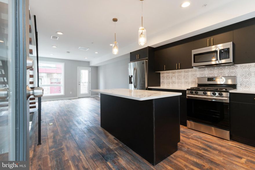 Step into luxury living with this stunning 3-bedroom, 2.5-bathroom townhome, newly constructed in 2021 and boasting high-end finishes throughout. 6 YEARS REMAINING ON TAX ABATEMENT under the old policy which means you are 100% abated on the building assessment for all of the remaining 6 years.  Comes with attached/covered garage parking!! You can then enter directly into the home via the garage. Nestled within the vibrant Perkiomen Courts community, comprising 24 homes, this residence offers the epitome of contemporary urban living. On the main level, discover a sleek, open-concept floor plan featuring a state-of-the-art kitchen adorned with custom soft-close wooden cabinets, a sprawling kitchen island, kitchen pantry and top-of-the-line stainless steel appliances. Adjacent to the kitchen, the expansive living area provides the perfect space for relaxation and entertainment. Ascend the floating staircase, a true architectural marvel crafted onsite, to find two bedrooms and a chic, modern full bathroom on the second level. The third level is dedicated to a lavish master suite, complete with a generously sized walk-in closet featuring built-in organizers, an opulent bathroom boasting dual vanities, and an oversized frameless shower stall. Venture up the spiral staircase to the rooftop deck, offering breathtaking views of the city skyline the ultimate venue for outdoor gatherings and sunset cocktails. Convenience is key with attached garage parking accessed via the community's common area driveway.  Enter the home through the garage.  No need to walk outside again.  A convenient half bath/powder room awaits as you enter through the garage. Dual zoned HVAC system.  Perfectly situated in the highly sought-after Fairmount neighborhood, this home is within walking distance to an array of cafes, bars, and restaurants. Francisville Park, just around the corner, provides an ideal retreat for pet owners. Enjoy easy access to the Ridge Ave corridor and the country's first ALDI superstore market. Commute with ease, as the subway system is just a few blocks away, offering quick access to the Art Museum, Center City, and beyond. With proximity to public transportation, shopping centers, and an abundance of dining and entertainment options, this residence truly embodies modern urban living at its finest.