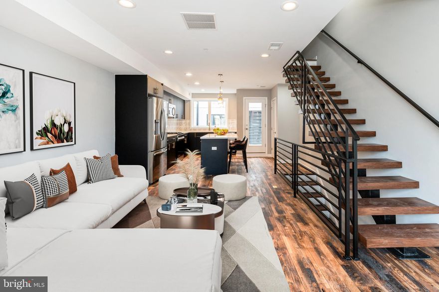 Step into luxury living with this stunning 3-bedroom, 2.5-bathroom townhome, newly constructed in 2021 and boasting high-end finishes throughout. 6 YEARS REMAINING ON TAX ABATEMENT under the old policy which means you are 100% abated on the building assessment for all of the remaining 6 years.  Comes with attached/covered garage parking!! You can then enter directly into the home via the garage. Nestled within the vibrant Perkiomen Courts community, comprising 24 homes, this residence offers the epitome of contemporary urban living. On the main level, discover a sleek, open-concept floor plan featuring a state-of-the-art kitchen adorned with custom soft-close wooden cabinets, a sprawling kitchen island, kitchen pantry and top-of-the-line stainless steel appliances. Adjacent to the kitchen, the expansive living area provides the perfect space for relaxation and entertainment. Ascend the floating staircase, a true architectural marvel crafted onsite, to find two bedrooms and a chic, modern full bathroom on the second level. The third level is dedicated to a lavish master suite, complete with a generously sized walk-in closet featuring built-in organizers, an opulent bathroom boasting dual vanities, and an oversized frameless shower stall. Venture up the spiral staircase to the rooftop deck, offering breathtaking views of the city skyline the ultimate venue for outdoor gatherings and sunset cocktails. Convenience is key with attached garage parking accessed via the community's common area driveway.  Enter the home through the garage.  No need to walk outside again.  A convenient half bath/powder room awaits as you enter through the garage. Dual zoned HVAC system.  Perfectly situated in the highly sought-after Fairmount neighborhood, this home is within walking distance to an array of cafes, bars, and restaurants. Francisville Park, just around the corner, provides an ideal retreat for pet owners. Enjoy easy access to the Ridge Ave corridor and the country's first ALDI superstore market. Commute with ease, as the subway system is just a few blocks away, offering quick access to the Art Museum, Center City, and beyond. With proximity to public transportation, shopping centers, and an abundance of dining and entertainment options, this residence truly embodies modern urban living at its finest.