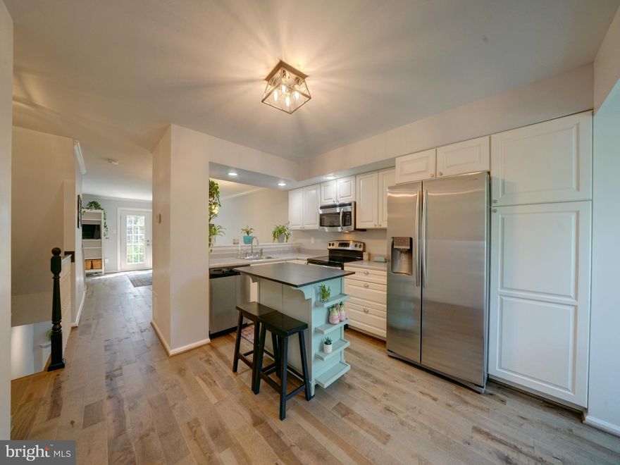 Welcome to beautiful 14203 Angelton Terrace!  This 4 level townhome updated with modern style is ready for new owners.  Almost everything has been renewed, including the big ticket items!  All in 2023, brand new Virginia Millworks solid hardwood floors on main and both upper levels, upgraded new carpet on the lower 
 level & steps, bright new half bath on lower level, all new metal and wood railings, LED lighting in kitchen and lower level.  Roof, siding, all doors and rear windows were all replaced 2017.  The heating and air conditioning was upgraded with a Carrier system in 2015.  All front windows were replaced 2013.  
Enter the main level to the bright open kitchen with stainless appliances, white cabinetry, recessed lighting and an island/breakfast bar.  A large pass through from kitchen to dining room allows natural light to flow.  
The spacious living room is set in the back of the home with hardwoods, neutral paint, and doors to the private back yard.  Conveniently, there is an updated half bath also on the entry level.  Most rooms have been freshly painted too!  Open the french doors to a gardener's delight with a flagstone path and flowering perennials to enjoy year after year.   Head up the hardwood stairs to the 2 bedrooms each with en suite baths.  Both bathrooms have stylish sinks with storage, elongated toilets, updated flooring, fixtures and mirrors.  Don't forget the extra space on the top level.  This loft can be a gym, office, craft area or whatever you want!
The lower level has nicely upgraded carpet on the steps and rec/family room, along with a cozy pellet stove in the fireplace.  The 4th bathroom was just remodeled, and is adjacent to the large laundry room.  An upgraded washer with steam feature  and dryer convey.  There is plenty of storage space too.  Assigned parking is directly in front.  Also, there is an unassigned spot next to it and others throughout the lot.
The neighborhood of Greencastle Lakes offers a large pool, community center, playgrounds and lakes, with easy access via a path system.  Stroll or bike while you enjoy the scenery.  Commute
 to Washington DC, Metro, NIH, JHUAPL, Fulton, Columbia, Silver Spring, and other metro areas by conveniently located Rt 29, Intercounty Connector Rt 200 and Rt 495 beltway. Schedule your tour today!