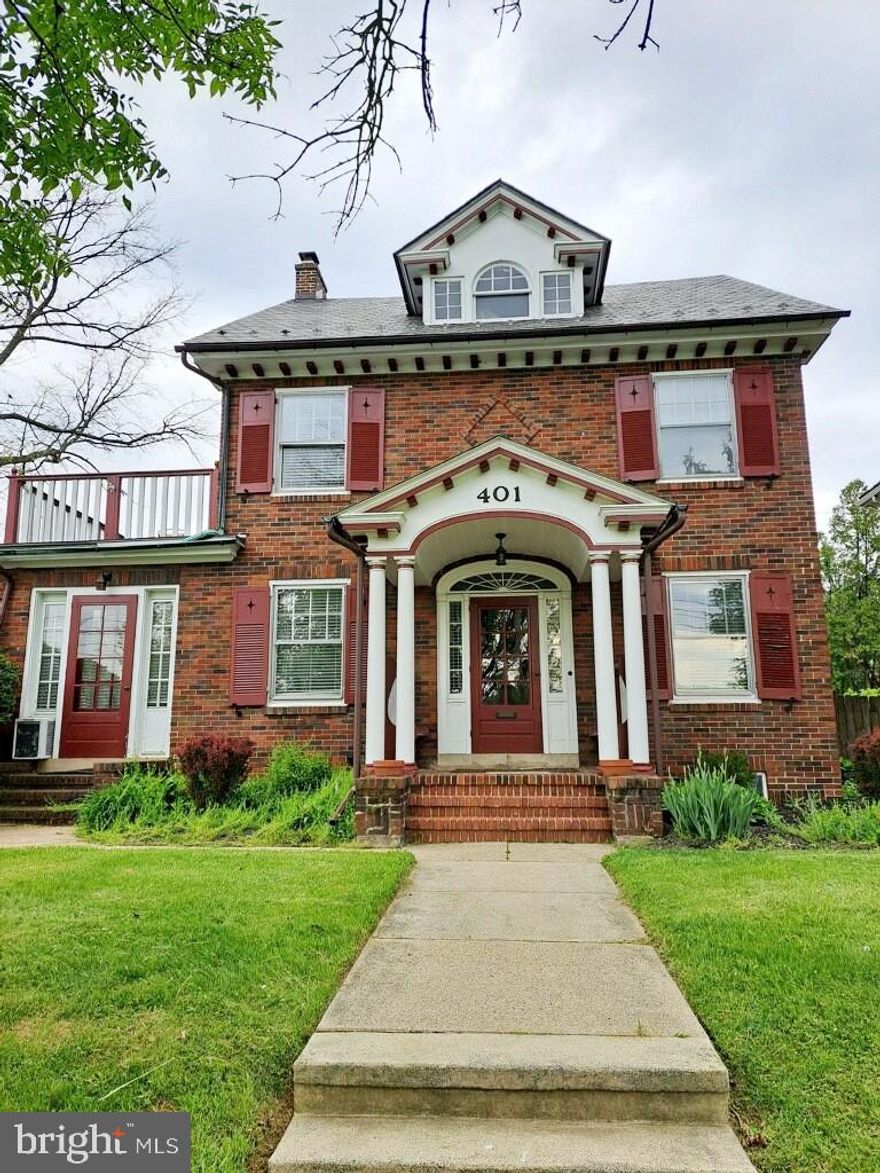 Step into this exceptional corner property with lovely curb appeal in the heart of Shillington—a home that blends timeless charm with rare versatility. From the moment you arrive, the historic brick facade, accented by classic shutters, graceful columns, and dual balconies, sets the tone for the character found throughout. The main home welcomes you with a light-filled, eat-in kitchen featuring white cabinetry, generous counter space, and tile flooring. Original hardwood floors continue through the formal dining room and into the spacious living room, where a beautifully detailed brick gas fireplace creates a warm and inviting centerpiece. French doors lead to a bright home office with its own separate exterior entrance, offering an ideal setup for a small business or private workspace.  The charm continues upstairs with four comfortable bedrooms and a full bath, while the fully remodeled walk-up attic offers a stunning additional bedroom with soaring 11-foot ceilings, new lighting, new carpeting, and abundant natural light—an unexpected retreat tucked beneath dramatic rooflines. Multiple heating sources, including gas radiant heat, mini-splits, and the gas fireplace, ensure year-round comfort. Outside, a private stone courtyard provides an inviting space for gathering, relaxing, or entertaining. Beyond the courtyard sits the spacious brick two-car detached garage with a private driveway. The property also includes a separate three-bedroom, one-bath rear apartment, complete with its own kitchen and living area—perfect for rental income, extended family, or limited commercial use permitted by zoning. Recently updated with all new LVP flooring, new doors, and fresh paint throughout. All of this is located just a short walk to the community pool, local parks, shopping, and schools, with right across from sought after Governor Mifflin High School, making this home a rare combination of space, charm, convenience, and income-producing potential. A truly one-of-a-kind opportunity in the heart of Shillington.  For investors looking to add this property to your investment portfolio; main home recently rented for $2,200 per month, the lower-level apartment for $1,400 and finally the office space separately projected at $900 per month, and detached garage rent for $300-$400 per month.  Included in the sale is the lighted double-sided sign for business that reaches a high daily traffic count.