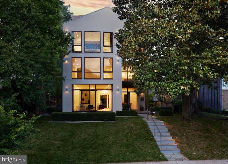 Situated on Potomac Avenue in the Palisades, and embraced by a tranquil park setting overlooking the Potomac River Basin, this distinguished residence promises an unparalleled lifestyle.

The striking centerpiece of the home, a dramatic floating staircase is flanked by sliding glass walls at both the front and rear of the home, creating a seamless indoor-outdoor living experience that invites natural light and a refreshing cross breeze. The residence showcases soaring ceiling heights up to 19', offering expansive wall space for art curators.

Step into tranquility within the Zen Associates designed Japanese Garden, complemented by an ionized black bottom heated pool and mature species plantings. The pool features an Ipe deck surround, offering a perfect spot to sunbathe with optimal sun exposure for 10 hours a day during the summer months.

Crafted for the connoisseur, the home includes an impressive 1500-bottle wine cellar, a media room, and an in-home gym for the fitness enthusiasts. The kitchen, designed by Leicht, is complemented with a Gaggenau induction cooktop and Miele appliance suite including the Miele Coffee System. Integrated refrigeration is by Leibler.

The Primary Suite features a private roof terrace nestled within a Magnolia tree. The bathroom, also designed by Leicht, is a sanctuary in itself. Featuring a centerpiece soaking tub overlooking the serene river basin, adjacent is a spacious walk-in shower as well as dual vanities and water closets.

Each additional bedroom is a treetop sanctuary within itself offering en-suite baths, ensuring utmost convenience and privacy.

The 7,800 square foot home is accented by in-floor radiant heat on the first floor, whole home water filtration, and an EVR system that balances humidity and temperature throughout the residence. Secure parking includes a 2-car garage and an additional surface parking space. 

Conveniently located just a two-minute walk to the Capital Crescent Trail and within short distances to fine dining such as Claudio's Table and Et. Voila, this home offers the epitome of luxury living in a coveted location.