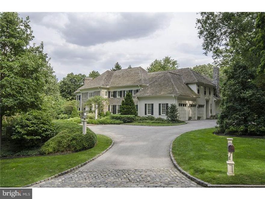 Classic & refined stone Manor home set on one of the Main Lines most venerable streets,offers elegant & light-filled interior spaces on maturely landscaped 1.37 acres w/pool. Stone walk leads to a gracious Center Foyer w/wide cased openings to the step down L/R w/f/p & D/R, both generously sized for formal entertaining. Fully paneled cherry Library is enhanced by a gas burning f/p and access to a blue stone Terrace. Chefs quality Kitchen is  brightened by white cabinets, & gleaming wide planked floors. A center granite island provides generous flat prep space & multi-person informal seating, while the breakfast area enjoys access to the rear terrace through multi-paned French doors & views of the property's rear yard & pool. F/R w/gas f/p is highlighted by a deep coffered ceiling. A tray ceiling in Master Bedroom w/gas f/p adds detail & volume while highlighting the rooms two exposures of light. Four add'l bedrooms. Finished LL offers storage area, gym, recreation space, media room & full bath.