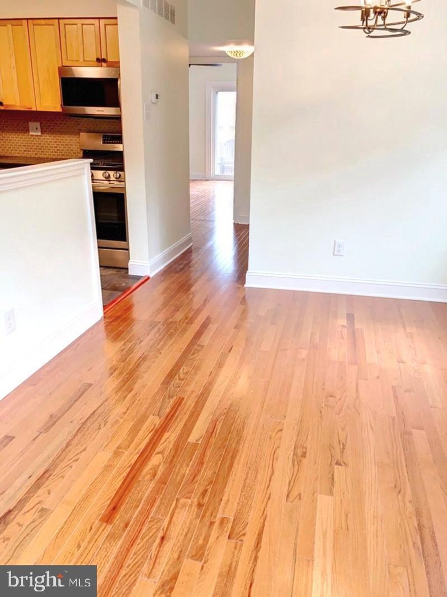 Beautifully renovated 2 bedroom / 1 bath with 2 car parking!!! One car is parked in the garage and the other is in the driveway. The unit has newer hardwood floors, the kitchen has a granite breakfast bar, a tile backsplash, and all-new stainless-steel appliances. New bathroom renovation. There is ample space in both bedrooms and great closet space. No hassle looking for parking space when you can drive into your spot and r park in the garage. Nestled in beautiful Queen Village, close to all shops and transportation. Each unit has a separate entrance.  There is a shared common outside space and a balcony off the bedrooms. This will not last long.