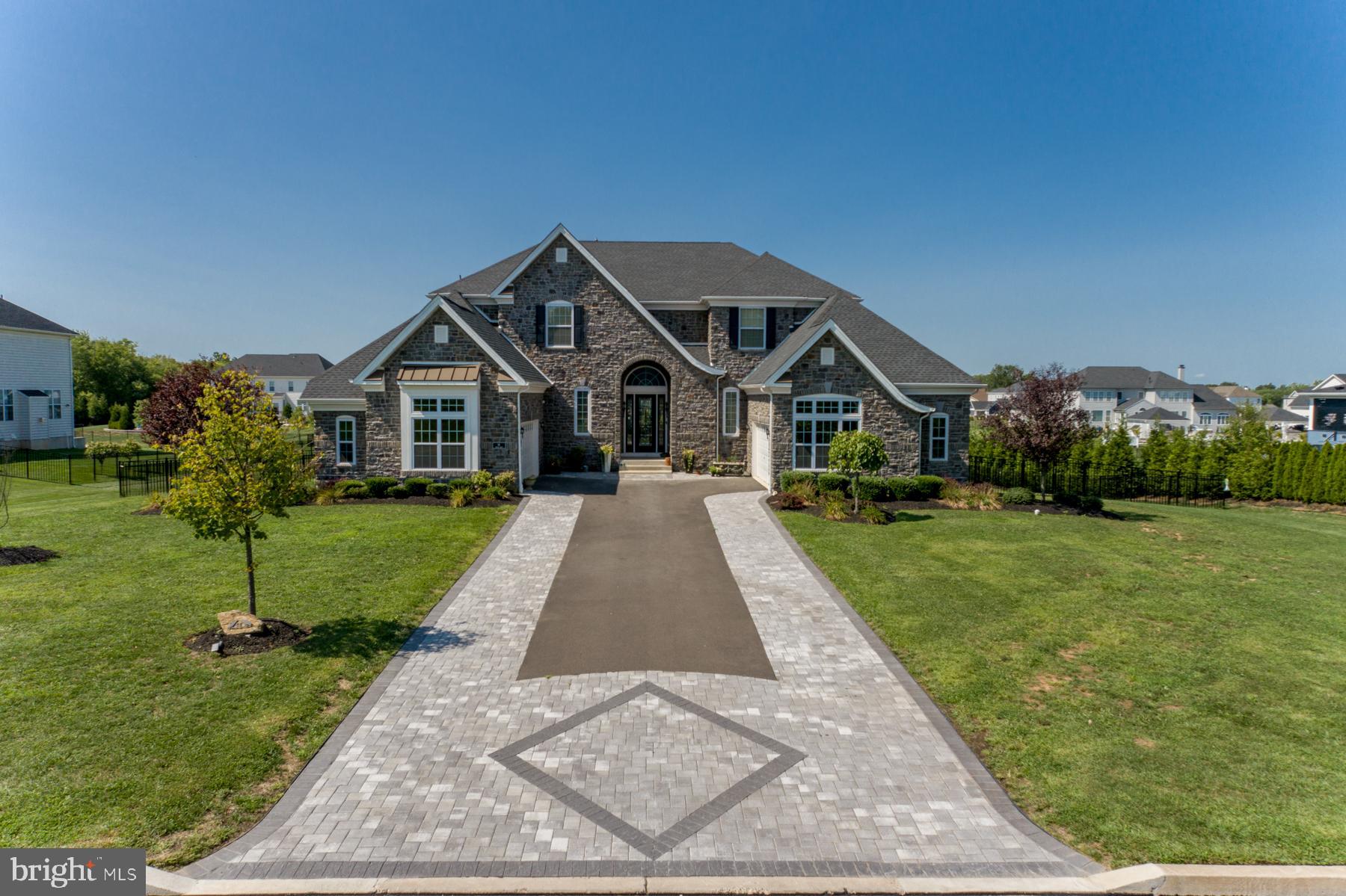 Welcome to 14 Oxford Drive in beautiful Bucks County! Situated in highly sought-after Reserve at Northampton, this 5 bedroom, 5 1/2 bath residence is truly a one-of-a-kind home with resort-style outdoor living space in the top-rated Council Rock School District! The list of Upgrades and Amenities both inside and out are truly Remarkable The outdoor living is spectacular, it is everything you could want and more. A one-of-a-kind, 40,000-gallon pool with oversized hot tub, fountains, variable built-in tiki torch lighting and with a running rock stream and waterfall features puts you directly in paradise at home! This gorgeous backyard sits on one of the premium and largest lots in this subdivision giving you space for children's activities, picnics, entertaining, playground equipment - the possibilities are endless. As an extra feature for all of you pet lovers, there is a separate fenced in area off the kitchen for your pets! Superbly finished interior begin at the two-story entry foyer with its “Cinderella” staircase topped with a custom railing and custom coffered ceiling and crystal chandelier. The formal and more casual living spaces showcase custom moldings and millwork, carefully designed lighting, wood floors, custom window treatments and window shades. Refined formal rooms, including a dramatic two-story dining room and inviting living room, are complemented by an expansive kitchen and family room with beautiful deep, coffered ceiling. The kitchen now has an oversized island and window, upgraded cabinets and “level 10” granite countertops. The stainless top of the line appliances (refrigerator, beverage refrigerator, microwave and oven and extra-quiet dishwasher), Pur2o whole house and drinking water system, 6-burner gas range with double oven and griddle and range hood accommodate every level of cooking and entertaining. A true Chef's Kitchen. Large Trex deck with illuminating features built in. The family-living area, is extremely spacious with an abundance of natural sun light. The first-floor study is perfect for work-at-home individuals. For flexibility, there is a first-floor guest suite or In-law suite featuring a full bath and a large walk-in closet. A first-floor laundry room accommodates a full-size washer and dryer as well as a scrub sink. A powder room, and entry area to one of two, two-car garages, completes the first floor. Private quarters upstairs include four bedrooms and three full bathrooms. The owner’s suite has a sitting area, his and hers walk-in closets and custom newly renovated master bath, oversized walk-in rain shower, gorgeous backsplash with custom tile work. A princess suite with a full bath with tub/shower and two additional bedrooms with a Jack & Jill bath complete the second floor. As a bonus, the full finished walkout basement includes 9-foot ceilings; a full custom wet bar roughing ready to install wet bar of your choice. Also in the finished walk-out basement there is a full bath and ample storage. This is truly a one-of-a-kind home in a premiere neighborhood and ready for its new owners to make it their own and enjoy all the extras and amenities it has to offer.