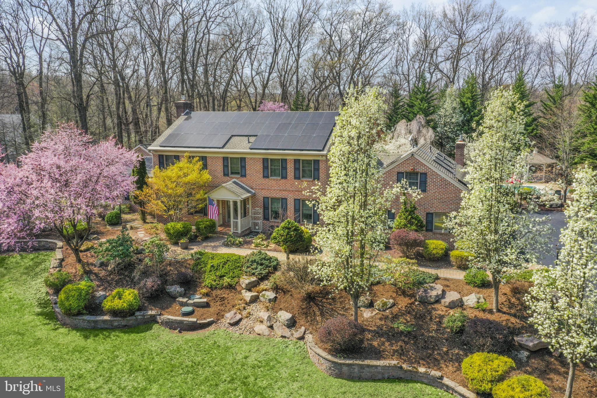 Welcome to this gorgeous, quality-built brick home nestled in the serene Angelica Woods neighborhood of Governor Mifflin School District. This property has the convenience of major roads being accessible but the privacy of a wooded lot. With a spacious attached in-law suite, this home is perfect for multi-generational living or hosting extended guests in comfort and style.
As you enter through the front door, you are greeted by a foyer with marble flooring and to the right a large formal dinning room that is currently being used as a home office. Hardwood flooring extends throughout the main and upper levels, and muted color palettes make decorating a breeze. The kitchen is perfect for entertaining with rich cherry cabinetry, granite countertops, a tile backsplash, cooktop, wall oven, and a large center island with seating. The kitchen opens to a dining area with a Tiffany-style light fixture. Go through French doors to a three-season sunroom. This space is surrounded by windows and equipped with its own mini-split system for year-round comfort.
Enjoy cozy evenings by the propane fireplace in the attached family room with built in shelving and bay window over looking the wooded property.
The main floor in-law suite includes a private exterior entrance and an interior entrance, full kitchen with patio views, a spacious living room with propane fireplace, a comfortable bedroom with built-in shelving, and a full bath with a walk-in tile shower and double vanity. Not to mention the oversized walk in closet. It's the perfect space to keep loved ones close while offering privacy and independence. This area is accessible from the main home via a shared butler's pantry.
Upstairs, the luxurious owner's suite includes an ensuite bath with granite countertops, double sinks, and a sleek walk-in glass shower. Three additional spacious bedrooms and a hall bath with double vanity provide ample space for everyone. The attic offers a spacious bonus area, a blank space for your ideas.
Off the kitchen there is a staircase to a guests suite with a sitting area, bedroom, and private full bath.
The finished basement features a full crafting area with custom cabinetry and granite counters, a wet bar for entertaining, and a home gym and tons of additional storage space.
The backyard could be your own private oasis. Enjoy the in-ground pool and/or evenings around a fire pit, or find shade and serenity in the gazebo. It is a nature lovers paradise.
A spacious three-car attached garage keeps your vehicles protected year-round.
This home offers the perfect blend of timeless elegance, modern upgrades, and flexible living spaces in one of Berks County’s most desirable communities.
Seller’s are willing to payoff solar panels for the right offer.