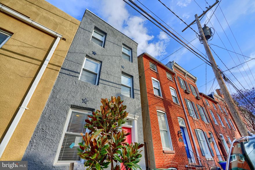 This beautifully renovated townhouse in Federal Hill offers the perfect blend of historic charm and modern amenities. This home is move-in ready. Freshly painted through out and gorgeous refinished floors. The spacious main level features exposed brick, hardwood floors, and a gourmet kitchen with a center island, and stainless steel appliances. Plenty of room for get-togethers in the cozy and private backyard  Upstairs, you'll find 3 bedrooms each with a bathroom. Washer and Dryer are conveniently located on the second level.  Breathtaking city views from the private rooftop deck. Steps away from shopping, restaurants, Camden Yards, and the Ravens. Perfectly located to enjoy all that Baltimore has to offer, with easy access to I-395  and the Inner Harbor.