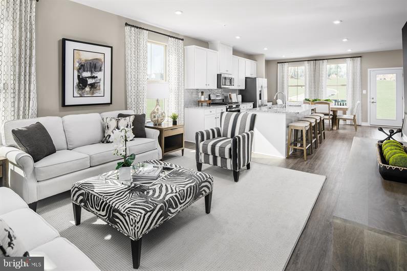*****ASK ABOUT CURRENT CLOSING COST ASSISTANCE************
QUICK DELIVERY BALLAD FLOORPLAN,(Est Delivery Jan 2025). Welcome to Parkside Reserve! One of Anne Arundel County’s most sought-after new construction townhome communities offering luxury garage townhomes in an exclusive, amenity-filled, resort style community located in the heart of Hanover, MD. This home includes, 1951 square feet, 3 bedrooms, 2 full and 1 half bath, Carlton designer palette, harbor cabinets, quartz countertops, washer/dryer, LVP on main level, hardwood stairs, stainless steel appliances. We offer a collection of homes that are designed to fit the way you live, making your day-to-day life easier and less chaotic. The To be Built Ballad, a beautiful 1-car garage townhome with the space and style of a single-family home. The ground floor foyer welcomes you inside toward a spacious recreation room, which could also become a guest suite with the addition of a full bath. Upstairs, a large great room is ideal for gathering with loved ones. An adjoining gourmet kitchen and dining space with a large island is perfect for making home cooked meals. On the 3rd floor, you’ll find two bedrooms and a full bath. Your luxurious owner’s suite features two walk-in closets and a dual vanity bath. The Ballad can’t be beat. End of Group homesites and wooded homesites will be subject to a premium. All photos are representative only. Other homesites may be available.
Parkside Reserve is conveniently located just minutes from I-295, Rte. 175 and Rt.32. This enables homebuyers to enjoy a convenient lifestyle close to everything. This makes it easy to get to the area’s employment centers, from major military bases to the Washington, DC, area. Plus, you are within 5 minutes of Hanover’s local amenities. Arundel Mills Shopping Center and Shops at Arundel Preserve are both nearby. Nearby stores range from Target to Home Depot. Restaurants include Lima’s, Southern Blues, and Pho One-O. Not only will you be upgrading where you live, but how you live. Come see why you will love all that Parkside Reserve has to offer.
