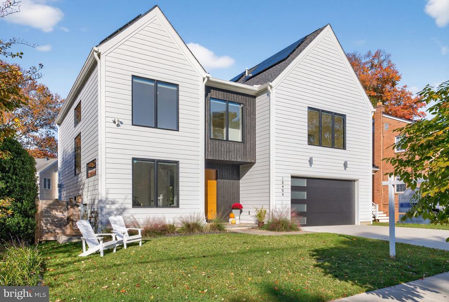 This pristine Scandinavian-inspired home is in a category of its own. Custom-built from the ground up and less than 4 years young, the finishes are superb. Crisp white Hardie lap siding converges with dramatic charred Yakisugi vertical siding at the covered main entrance. Environmentally and financially friendly, this home boasts a fully owned solar panel system. Exceptional features of the dazzling, sundrenched interior include solid white oak hardwood flooring, 9-foot ceilings on all three levels, large-scale Jeld-Wen windows and patio doors, custom shades, and a curated tile selection. Offering 5 bedrooms and 4.5 baths, the floor plan is open and efficient. Main level highlights include: 8-foot doors; a private office; a large living room with a charred cypress accent wall, discreet storage, and a 2-sided corner gas fireplace; an airy dining area with a sleek linear pendant light; a European dream kitchen with custom Marfa handleless cabinetry, an oversized contrasting center island, elegant quartz countertops and backsplash, Bosch stainless appliances, and a walk-in pantry; a mudroom with a built-in bench and cubbies against a shiplap wall; glass door access to the rear grounds. Flanked by a white oak slat wall and illuminated by oversized picture windows, the semi-open staircase ascends to the home’s upper level which offers a spacious primary retreat with an office alcove, 2 walk-in closets, and a gorgeous spa-like bathroom with a free-standing soaking tub, a curbless walk-in glass shower and double floating vanities. Two additional ample bedrooms, each with stylish ensuite bathrooms and walk-in closets, grace the front of the house. A phenomenal central family room and an adjacent laundry room complete the upper level. Providing wonderful overflow options and inviting space for guests, the daylit lower level offers a sizeable recreation room with a wet bar, two bedrooms each with walk-in closets, a full bath with a glass-enclosed shower and built-in bench, and a variety of storage options. Outside, a lovely flagstone terrace with a natural gas connection overlooks the large, lush fully fenced rear yard whereas a 2-car garage and concrete parking pad round out the front. Convenient to downtown Kensington, the Marc train, and two metro stations and in the Kensington-Parkwood/North Bethesda/Walter Johnson school zones, this location is ideal.
